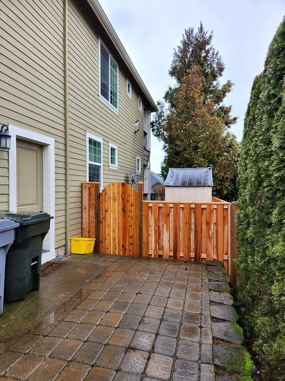 There is a wooden fence in the backyard of a house