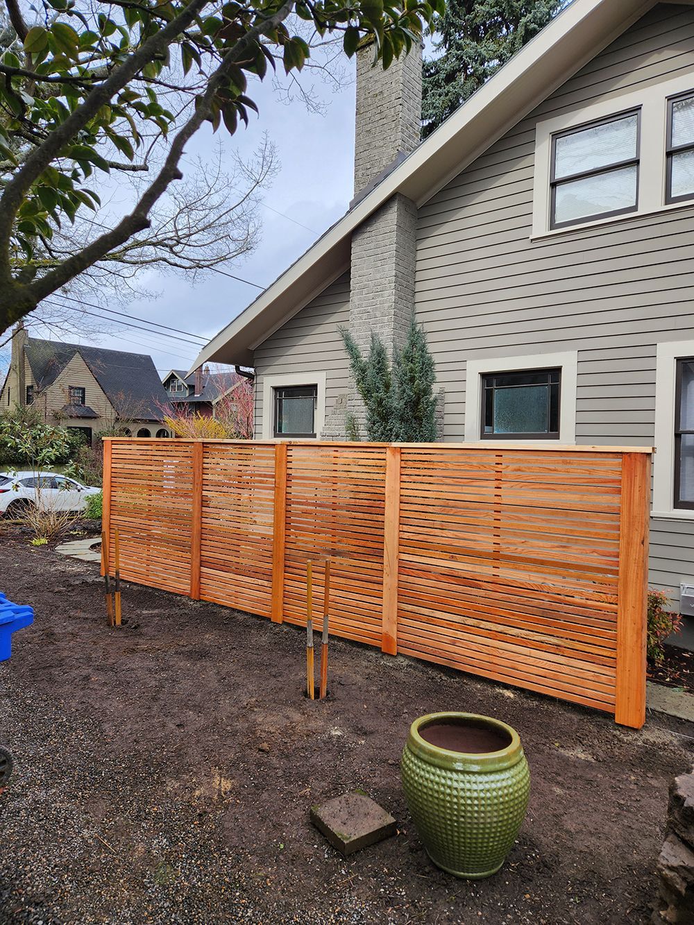 A wooden fence is sitting in front of a house