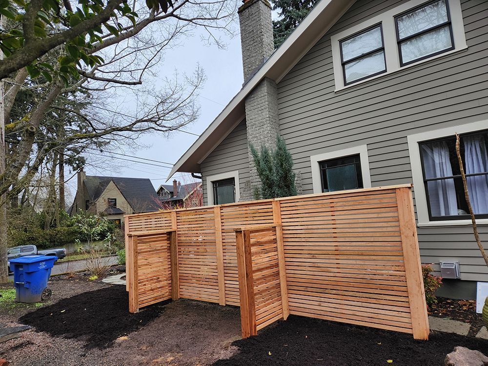 A house with a wooden fence in front of it