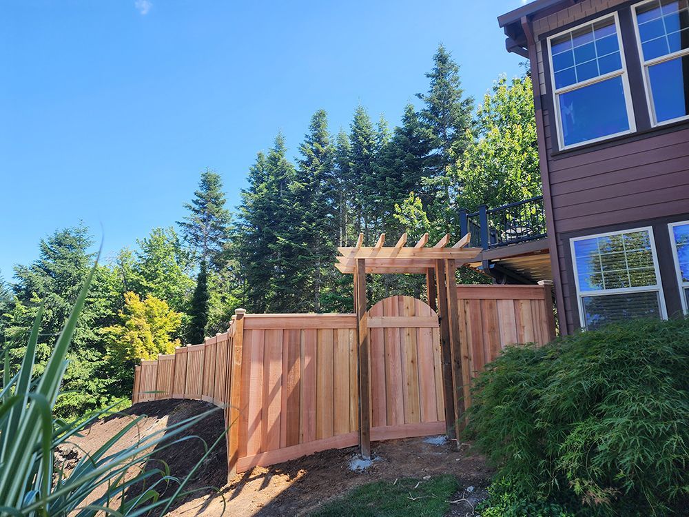 A wooden fence and gate are in front of a house