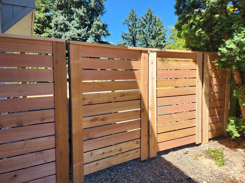 A wooden fence with trees in the background