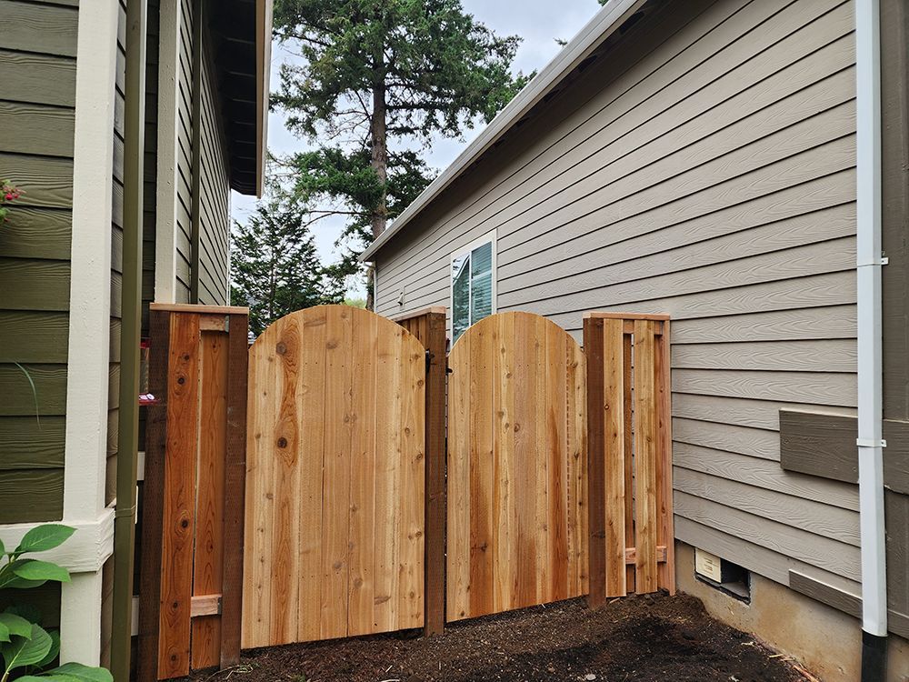 A wooden fence is in front of a house