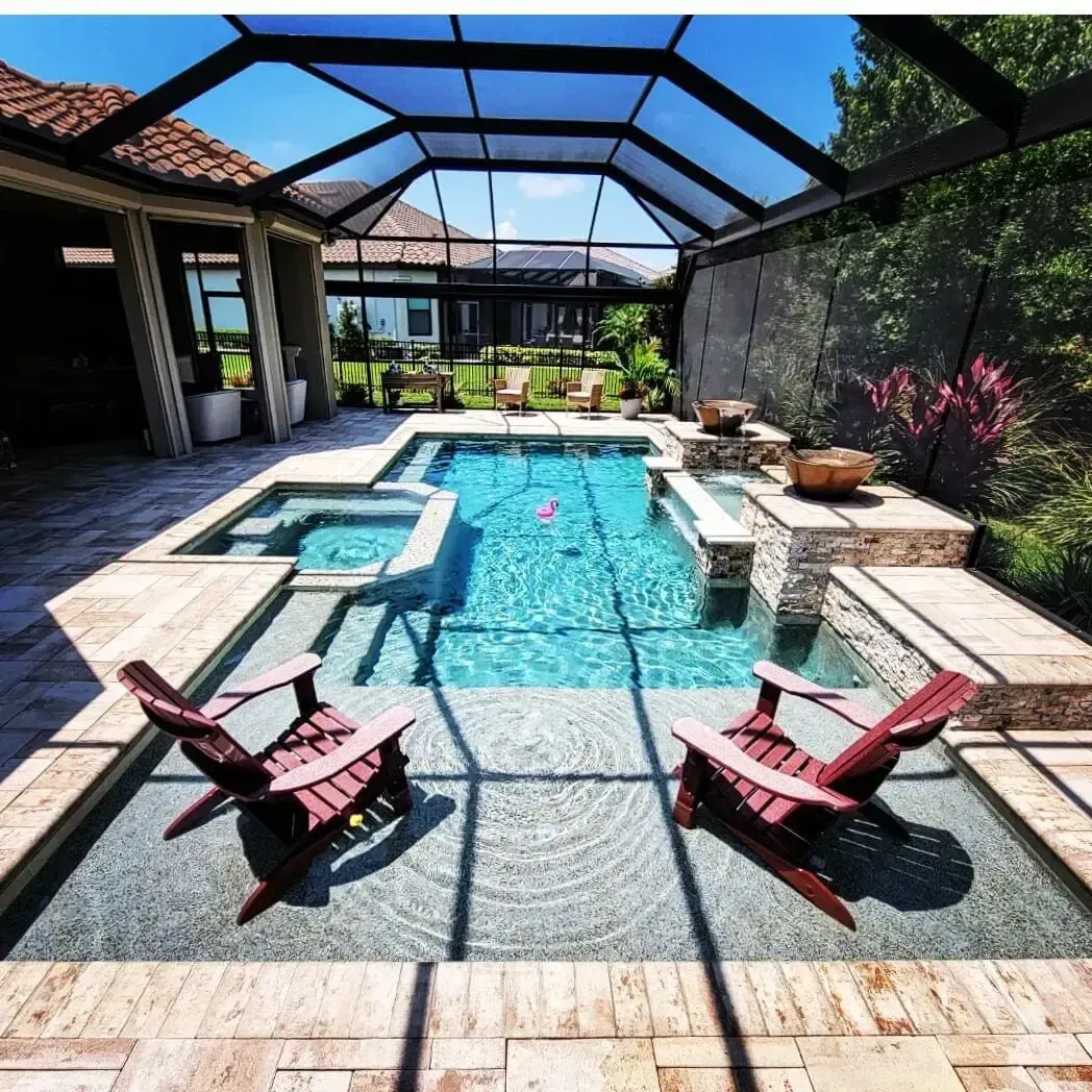 Two chairs sit in front of a large swimming pool