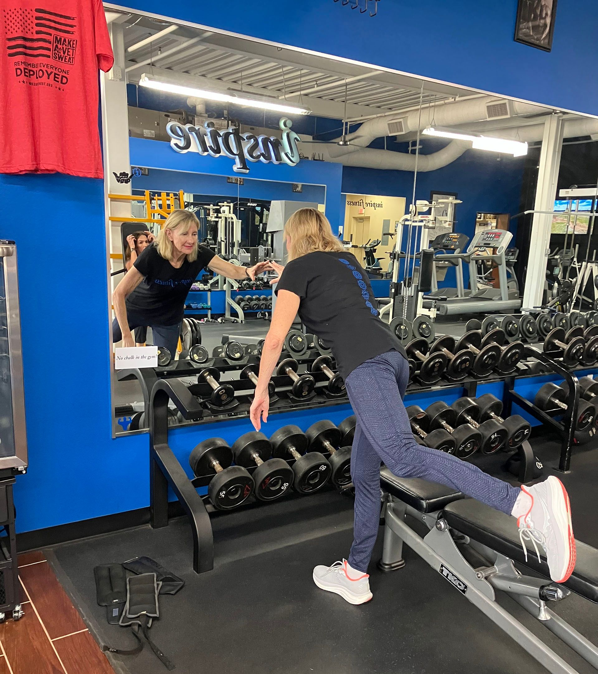 Senior female balance exercise with trainer