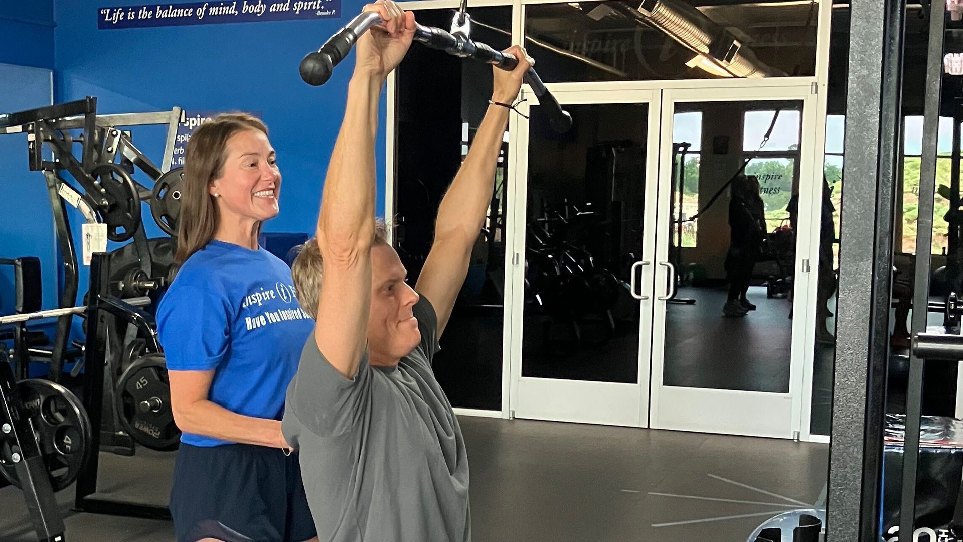 Female personal trainer coaching an adult over 40 during strength training in Cedar Park, Texas