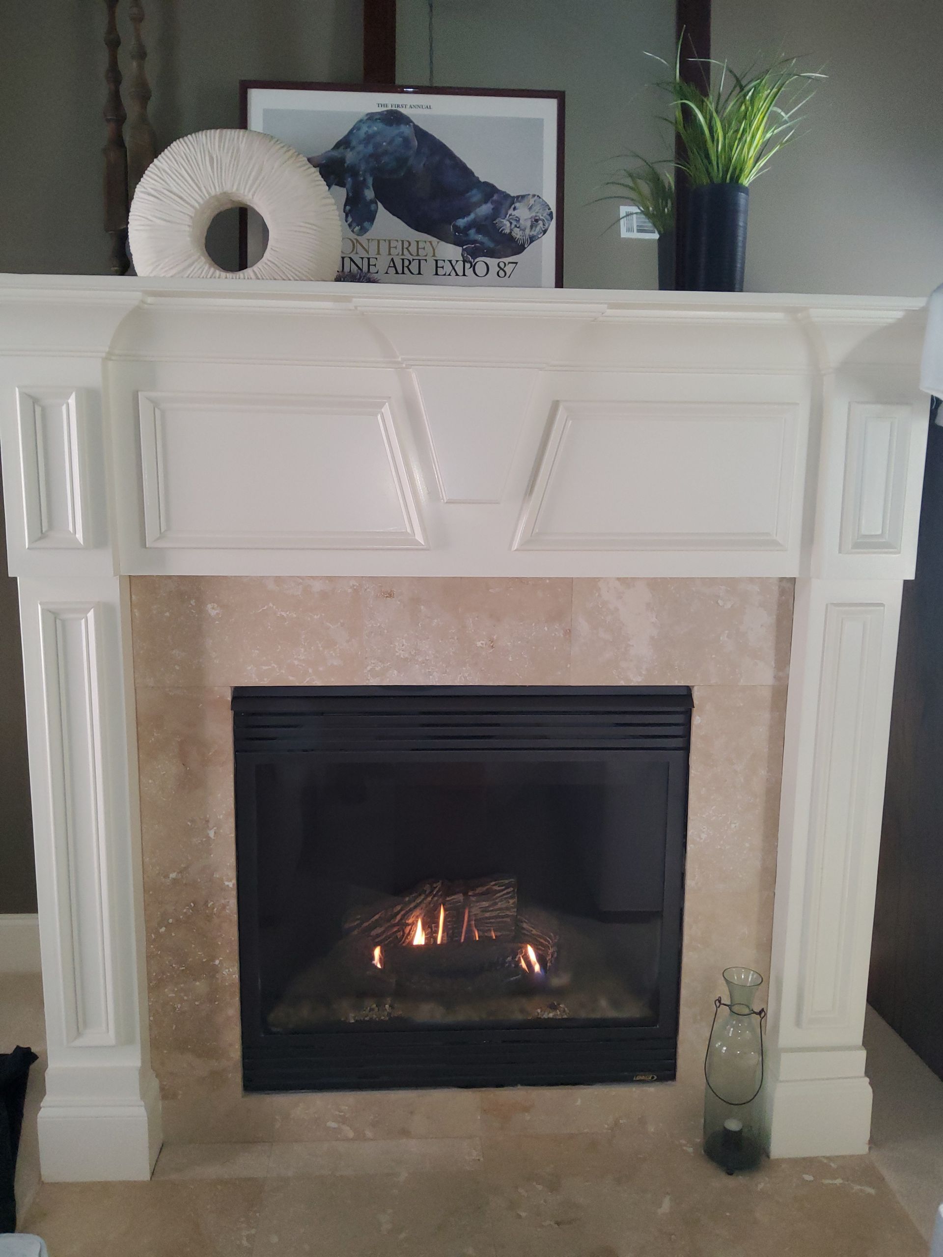 A fireplace with a white mantle in a living room
