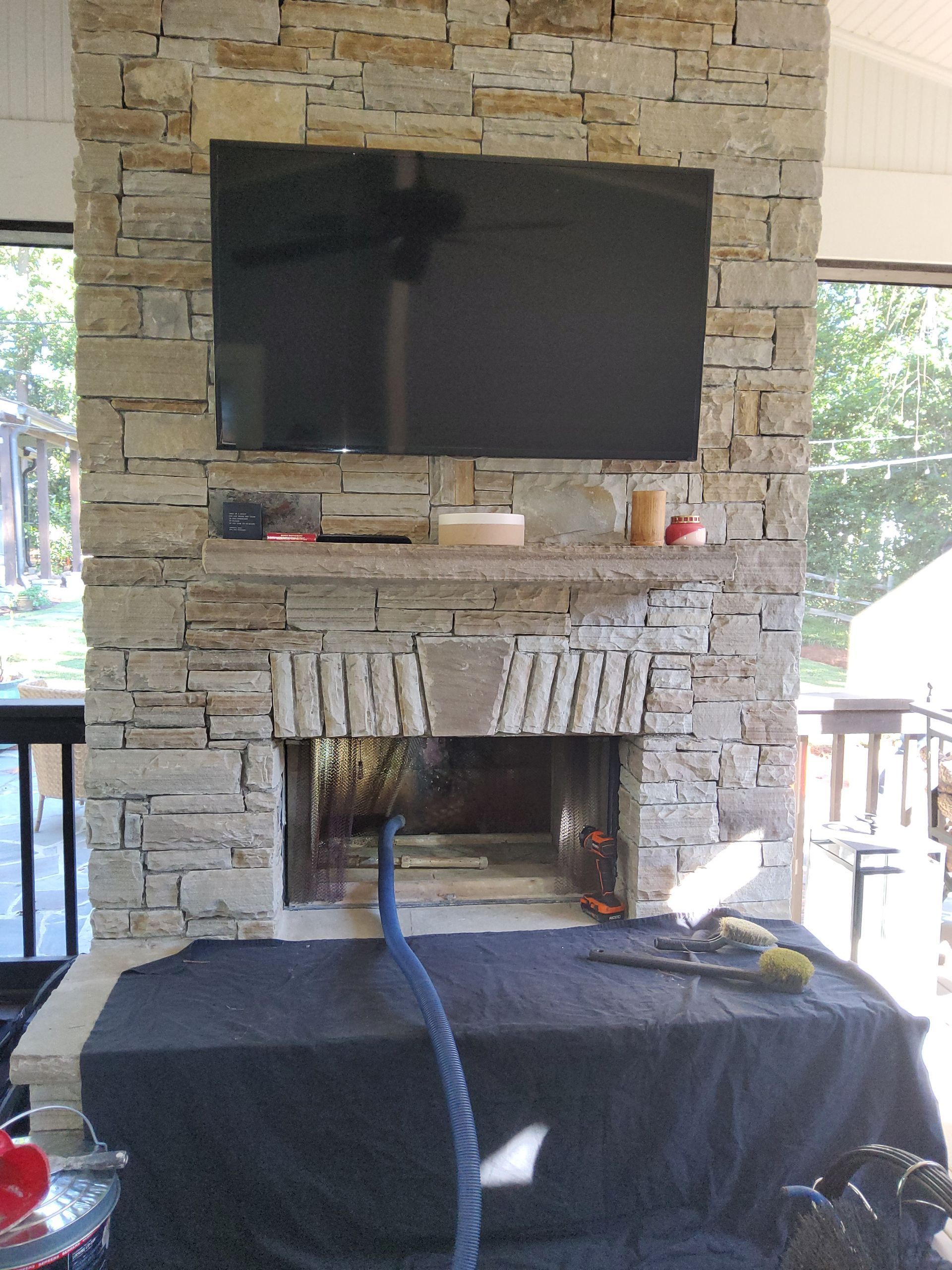 A fireplace with a flat screen tv mounted above it