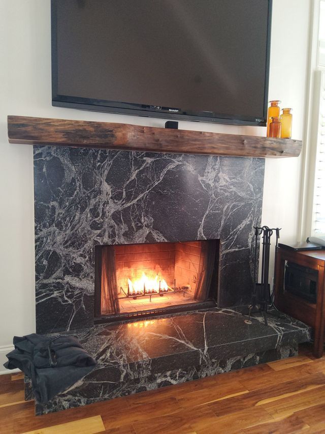 A fireplace with a television above it in a living room.