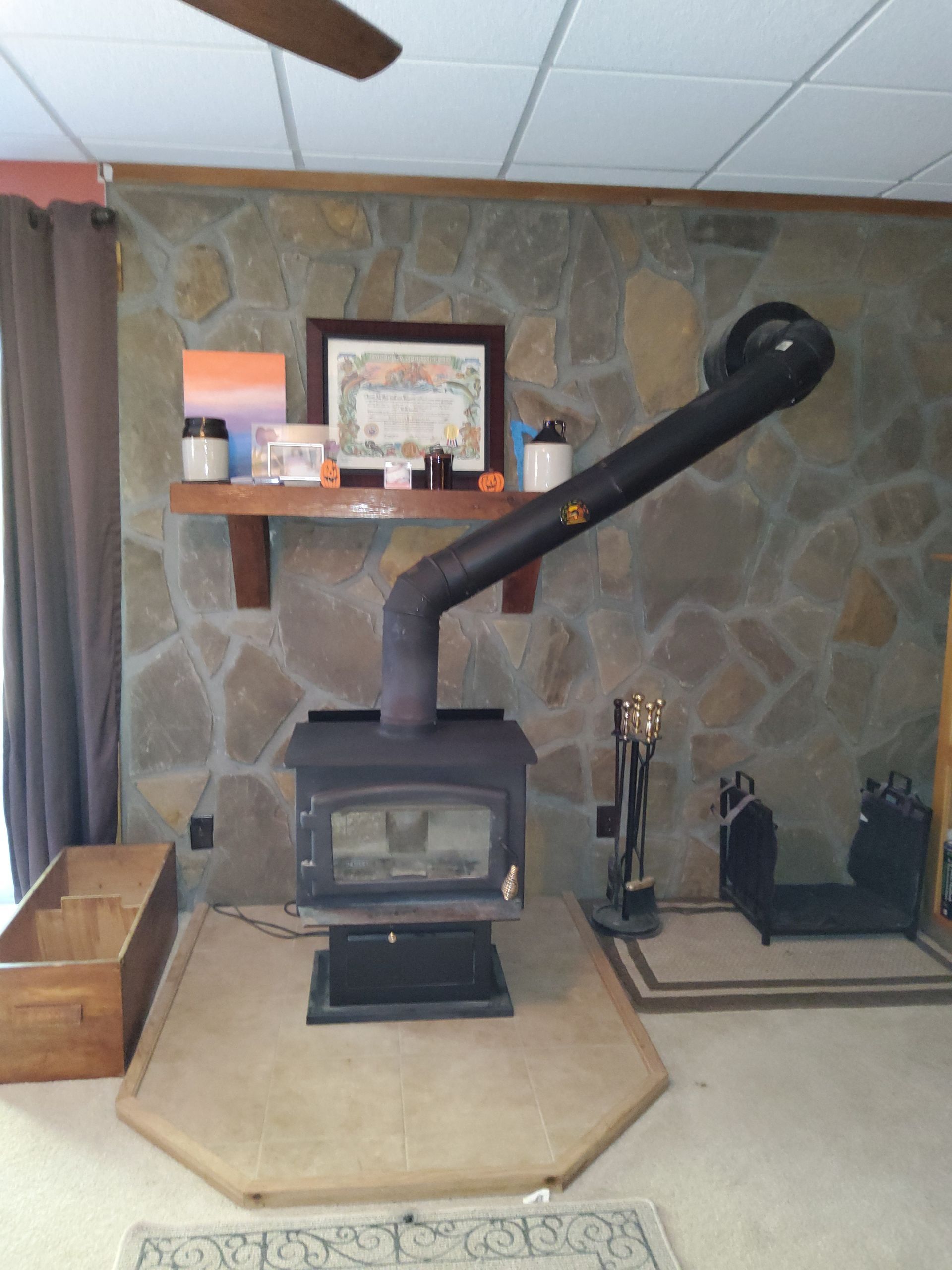 A room with a fireplace and a ceiling fan