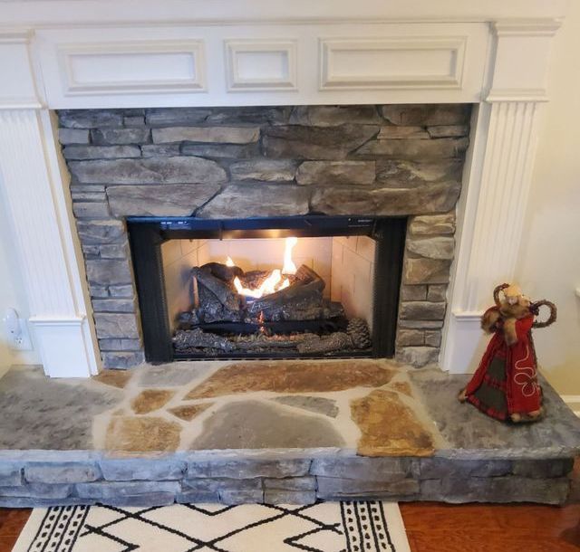 A fireplace with a statue of an angel on the mantle