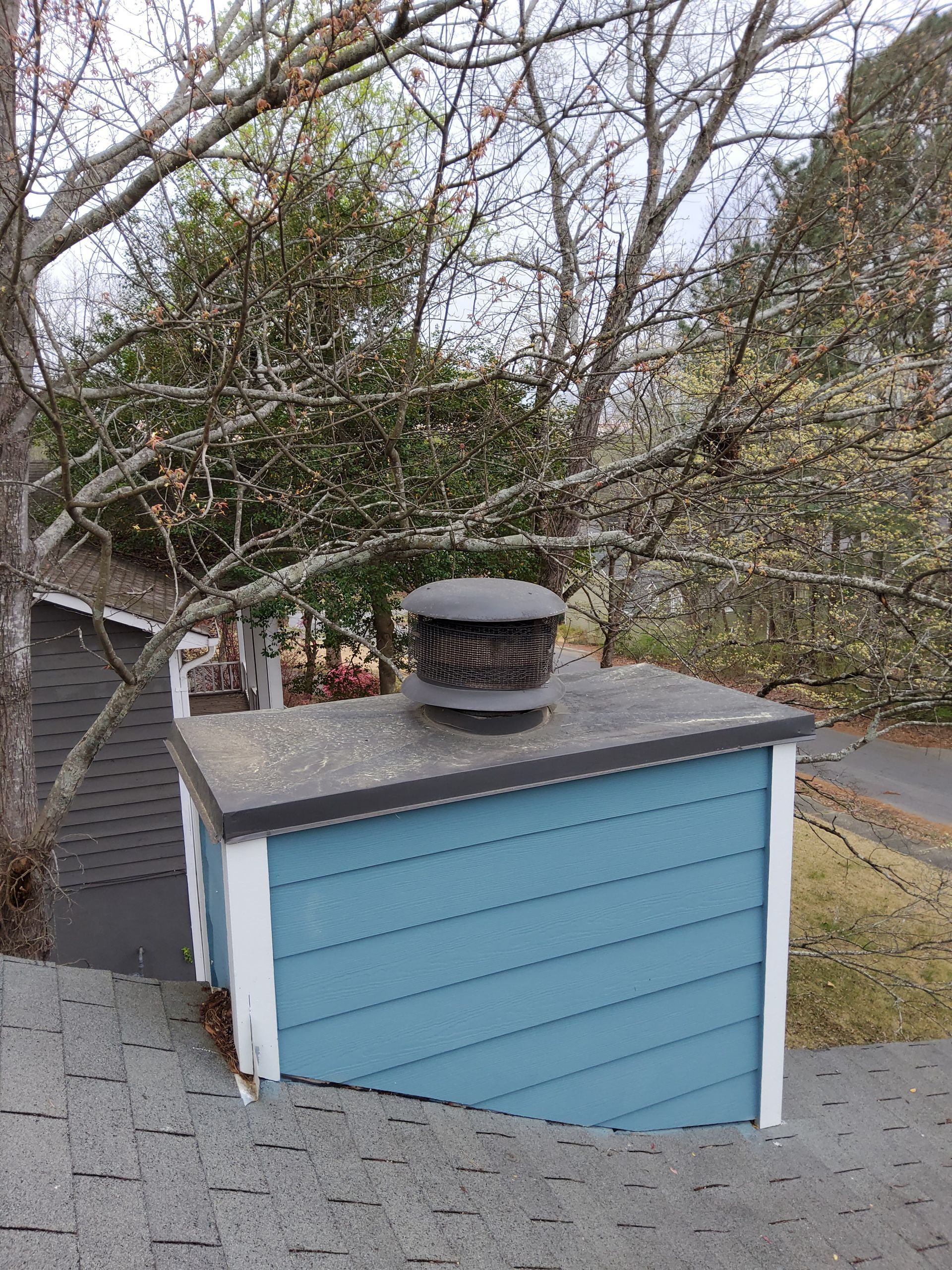 A blue building with a chimney on top of it.