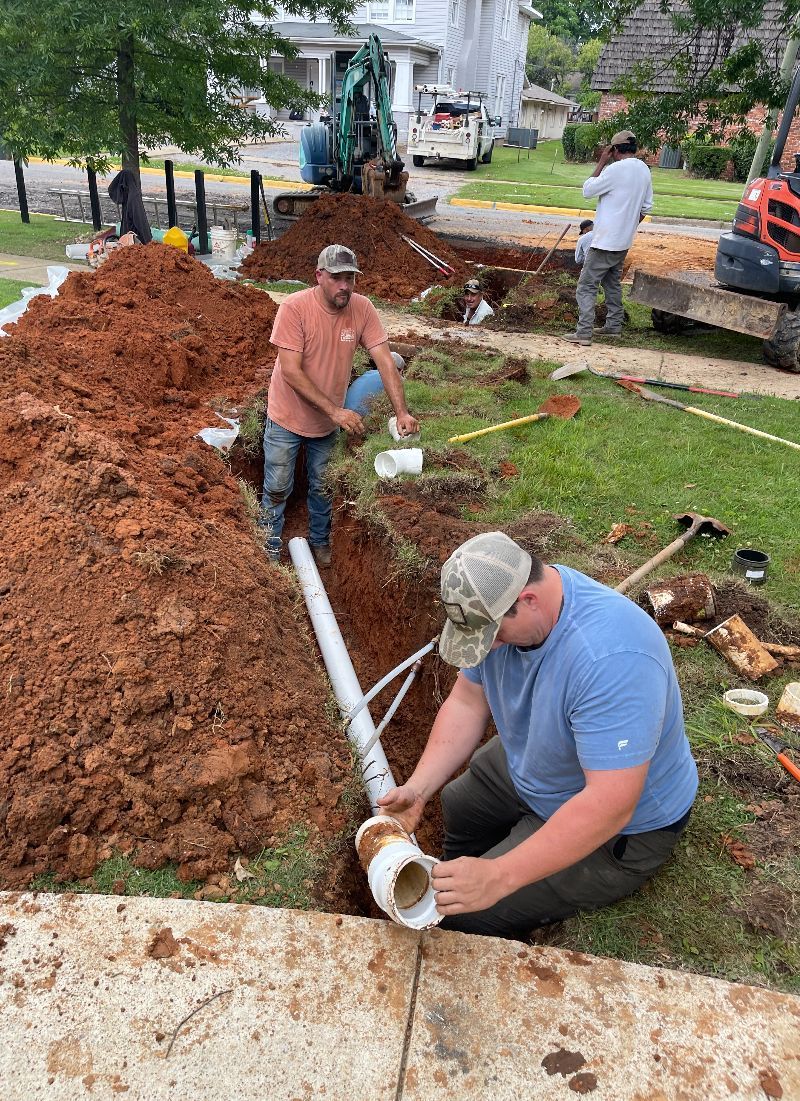 A plumber is fixing a sink pipe with a wrench.