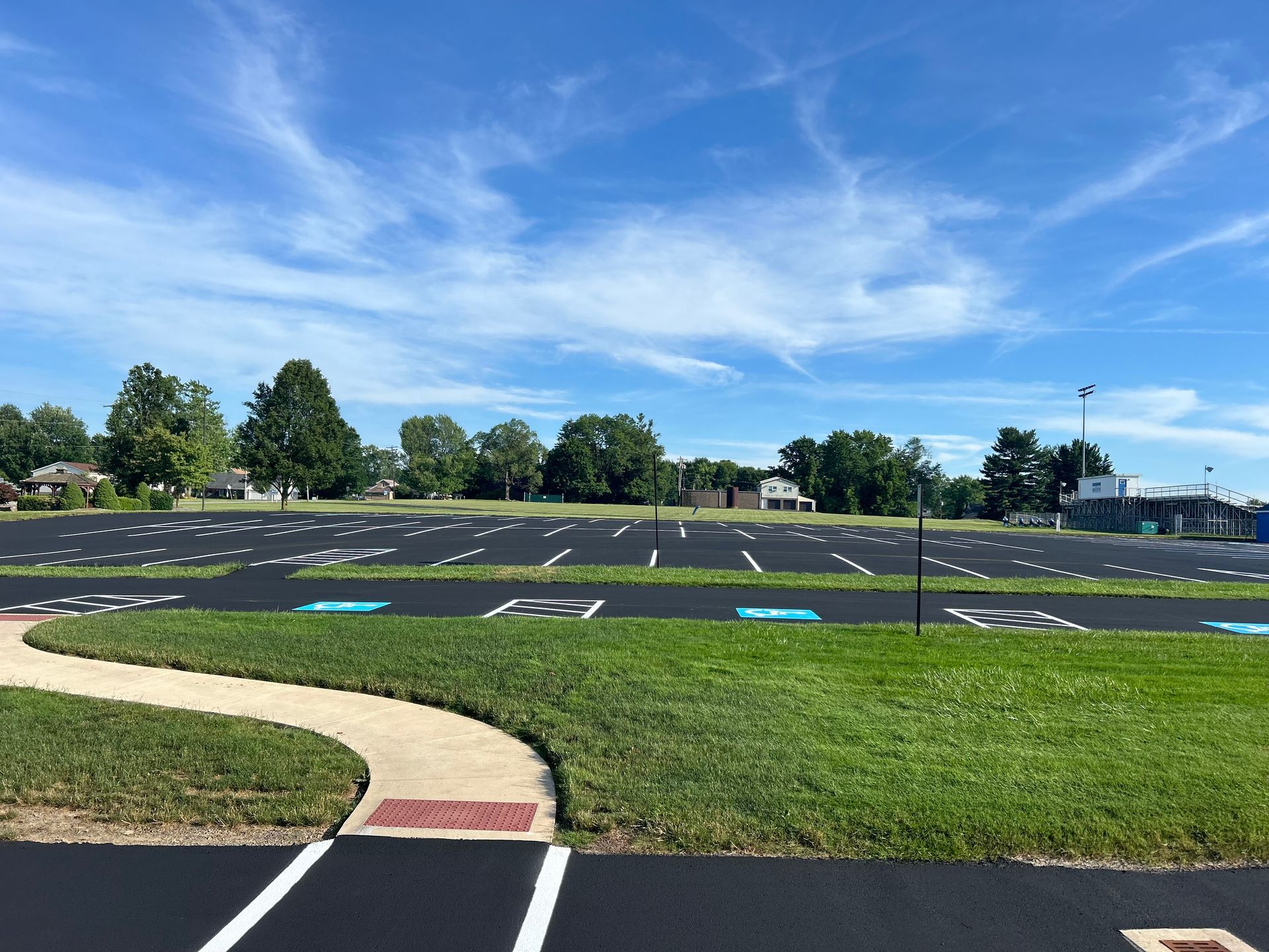 A parking lot with a path going through it on a sunny day