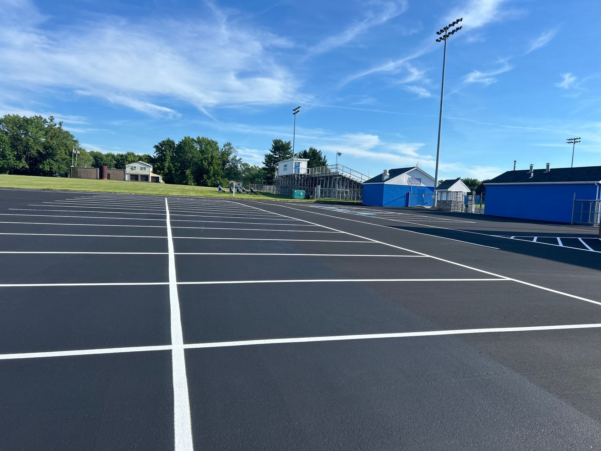 A parking lot with a blue building in the background