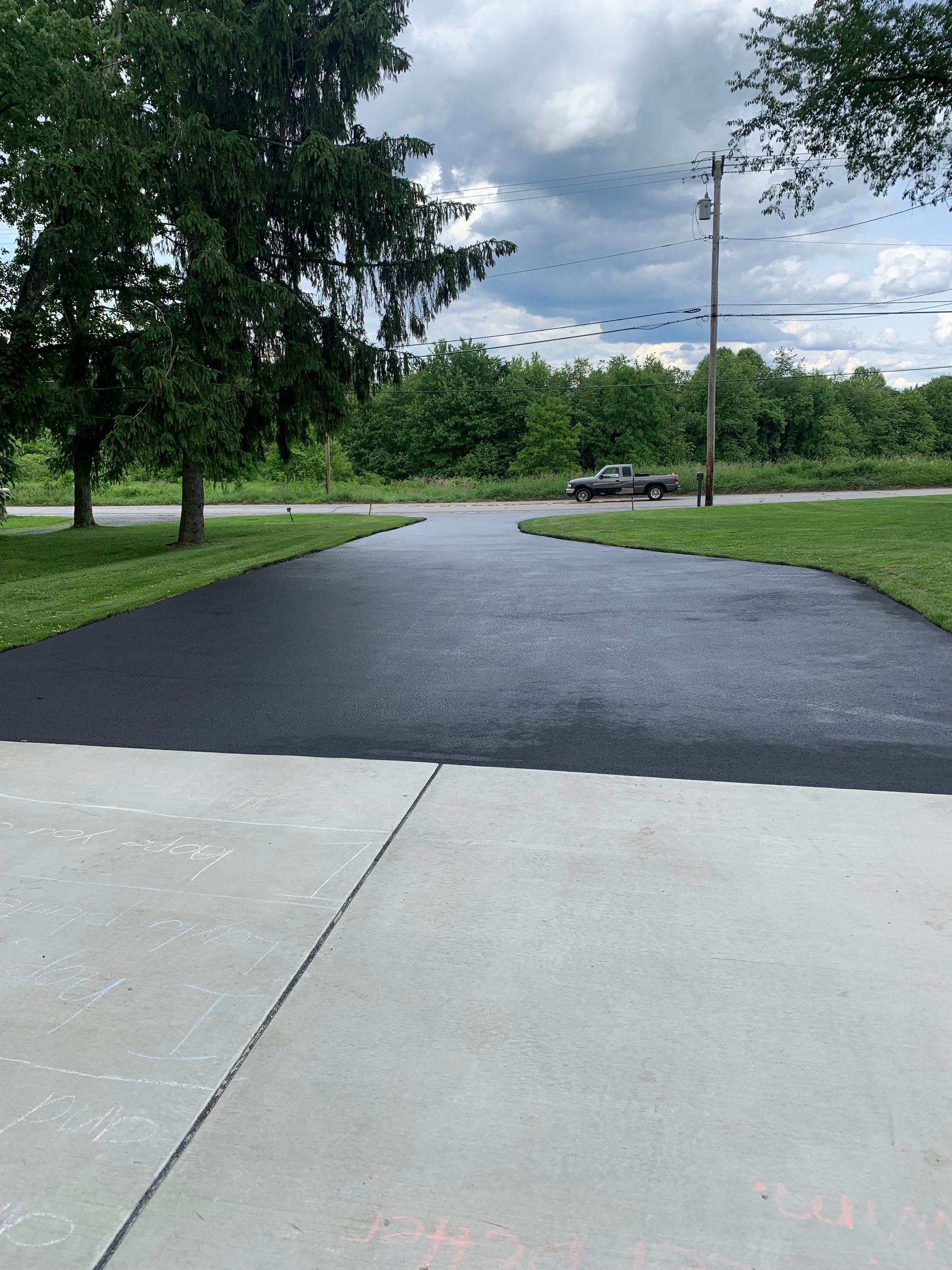 A black truck is parked on the side of a road