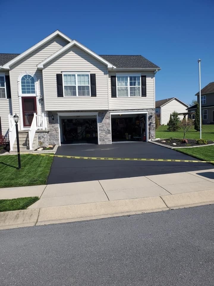 A house with two garages and a concrete driveway