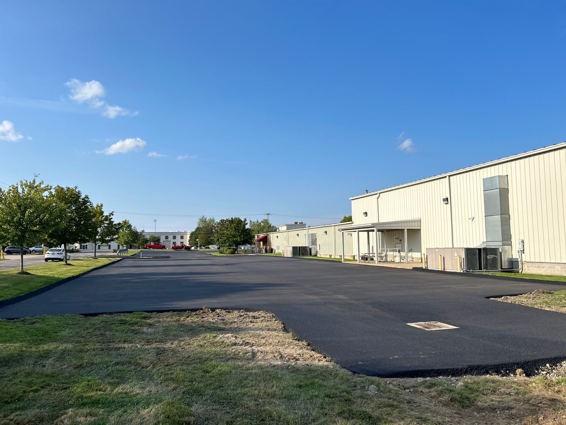 A large white building with a parking lot in front of it.