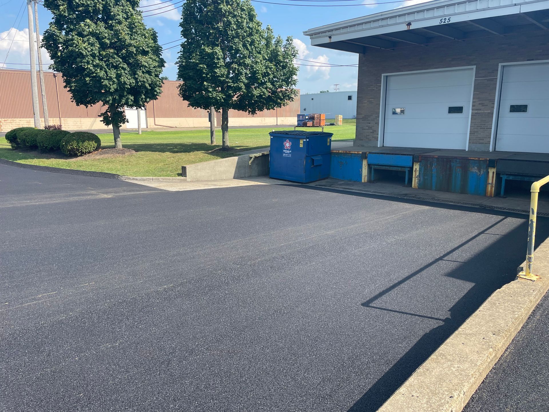 A parking lot with a brick building in the background