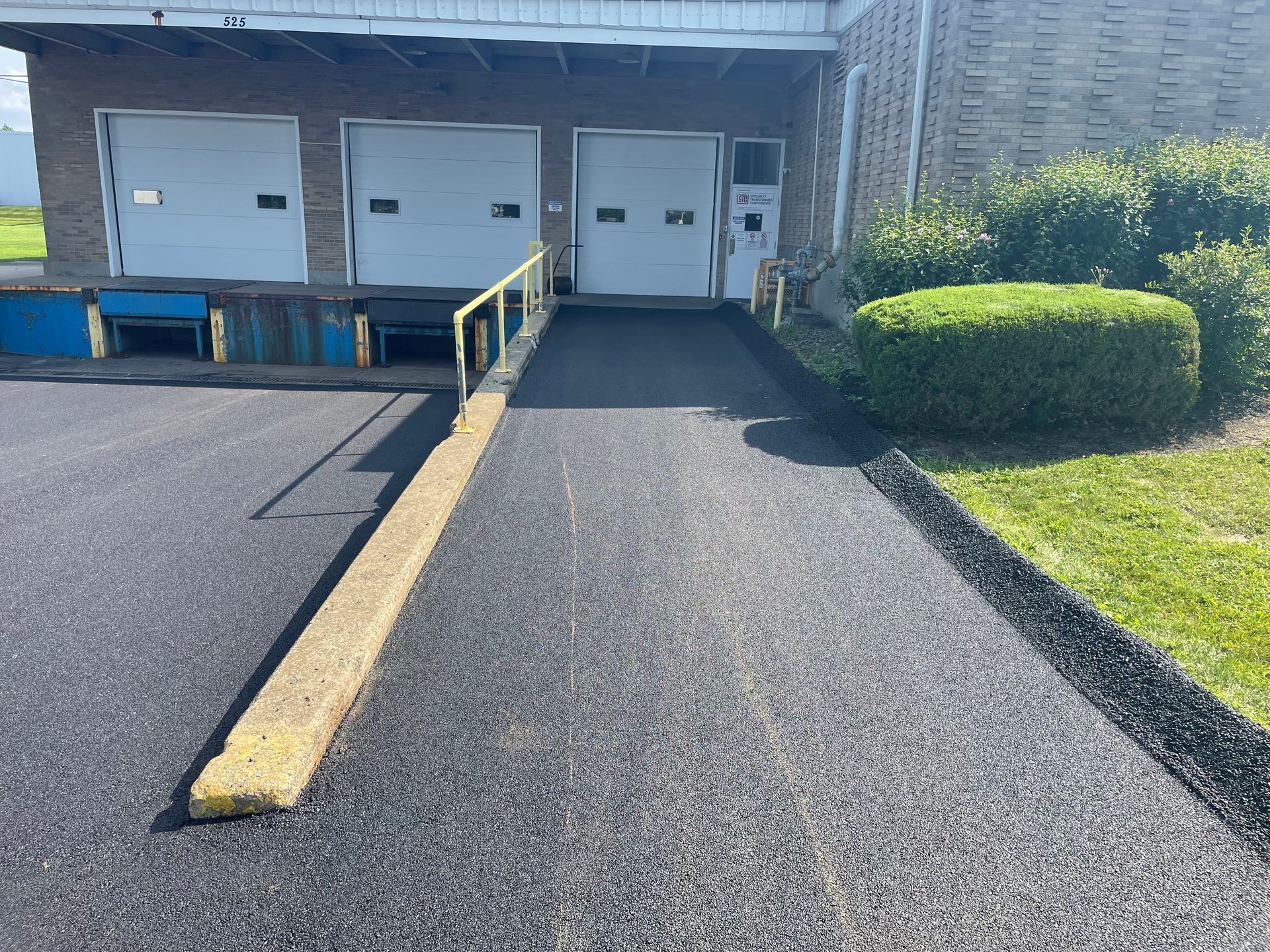 A parking lot with a ramp leading to a building
