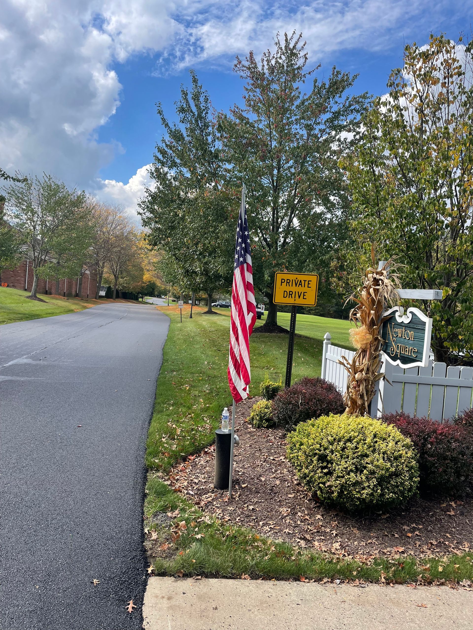 An American flag is flying on the side of a road