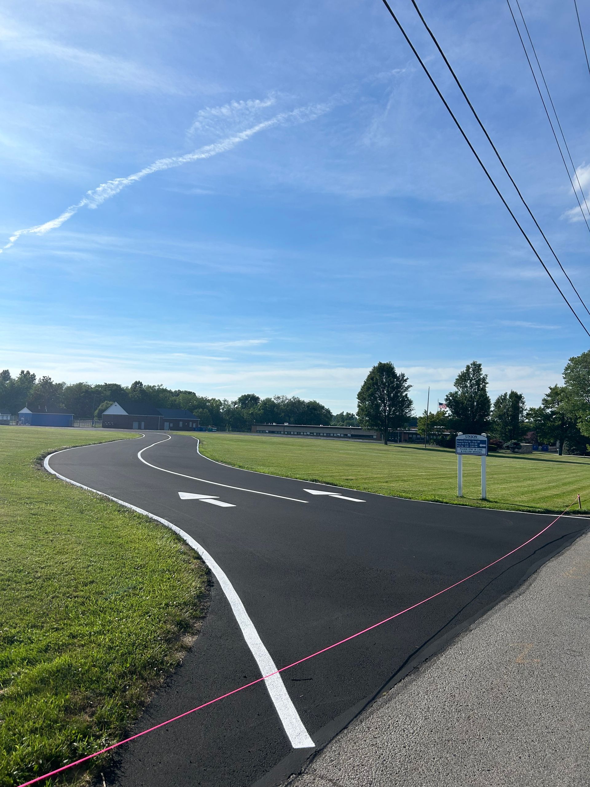 An American flag is flying on the side of a road
