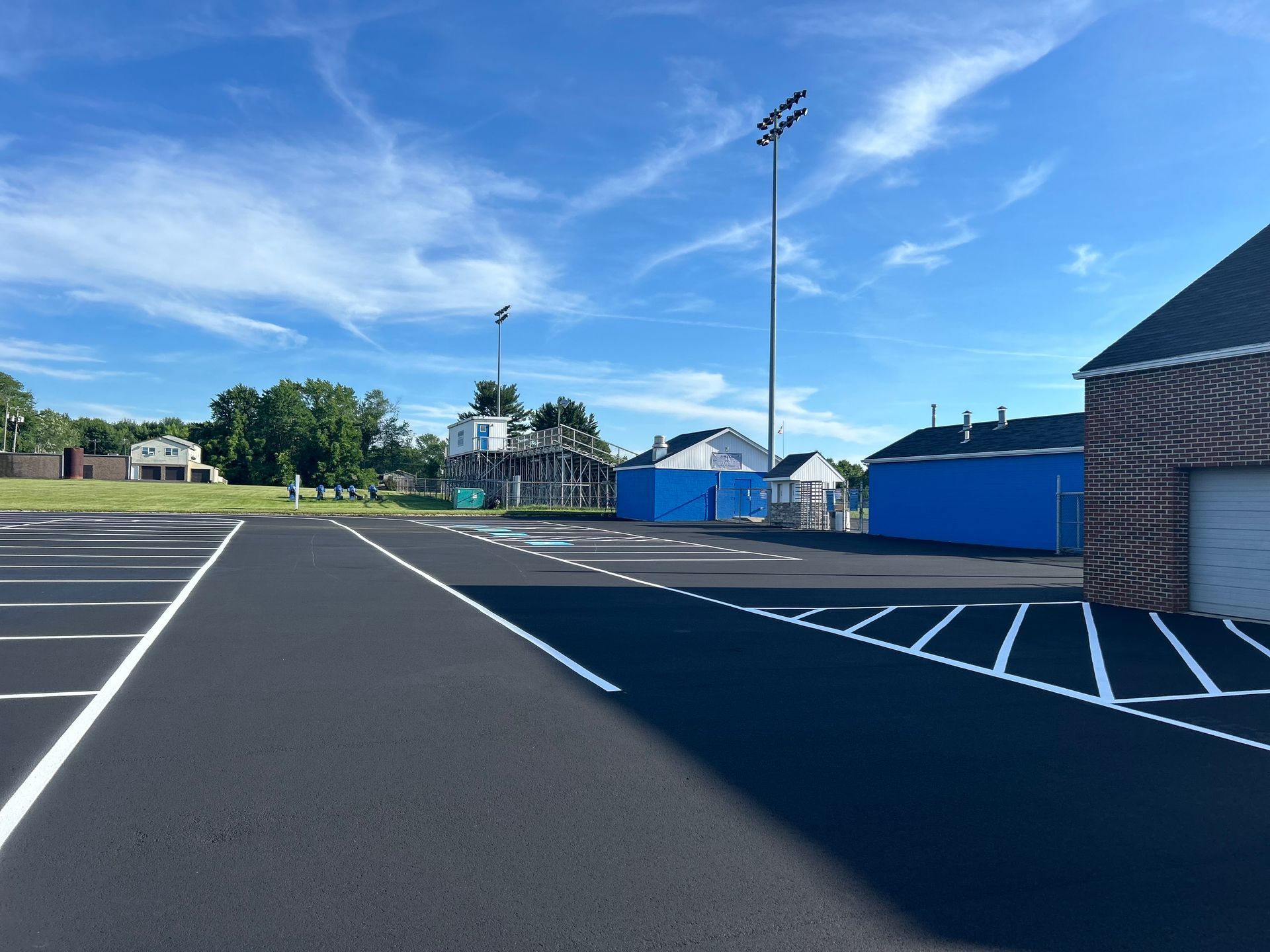 A parking lot with a blue building in the background