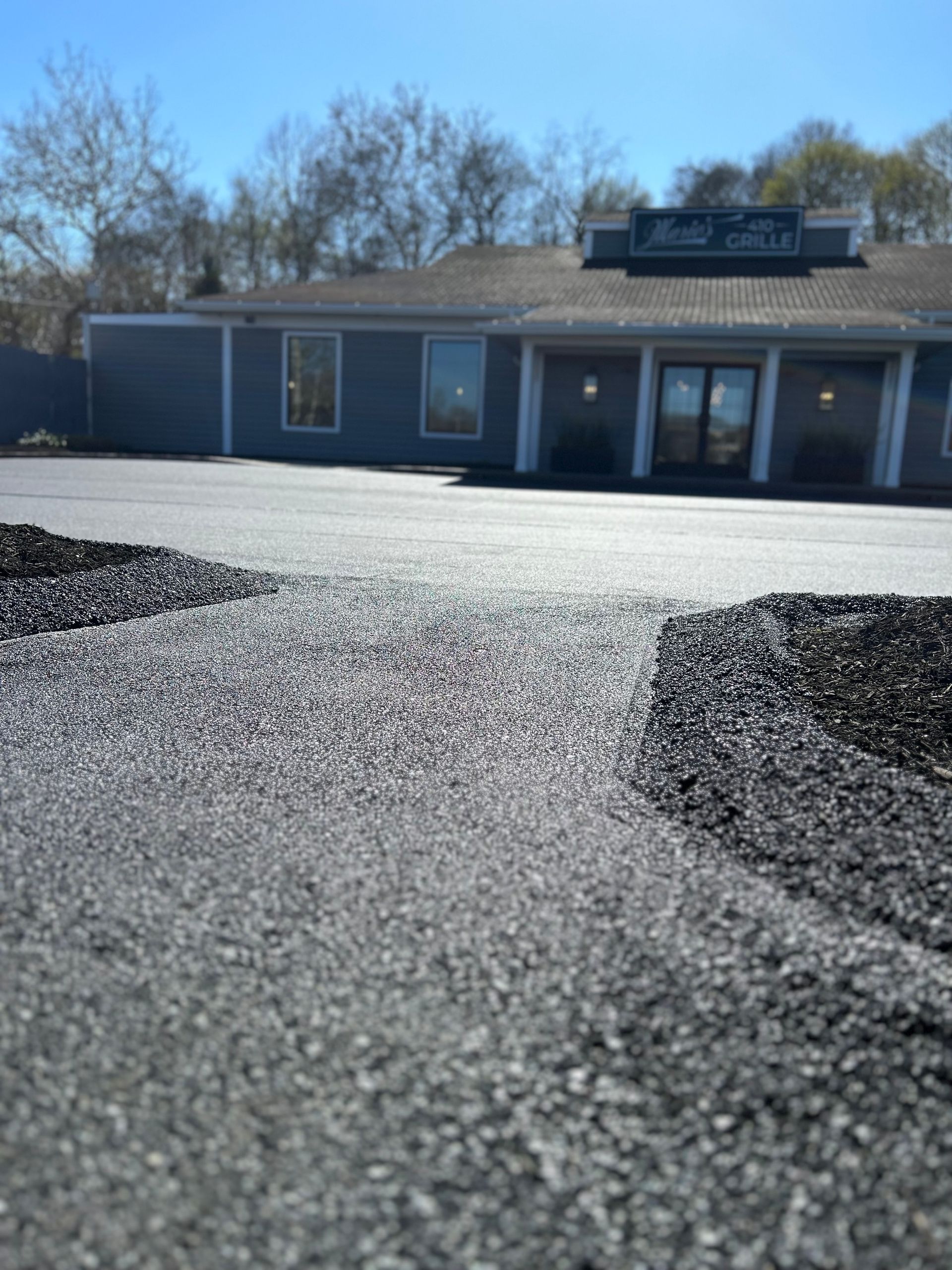 A house with a lot of gravel in front of it.