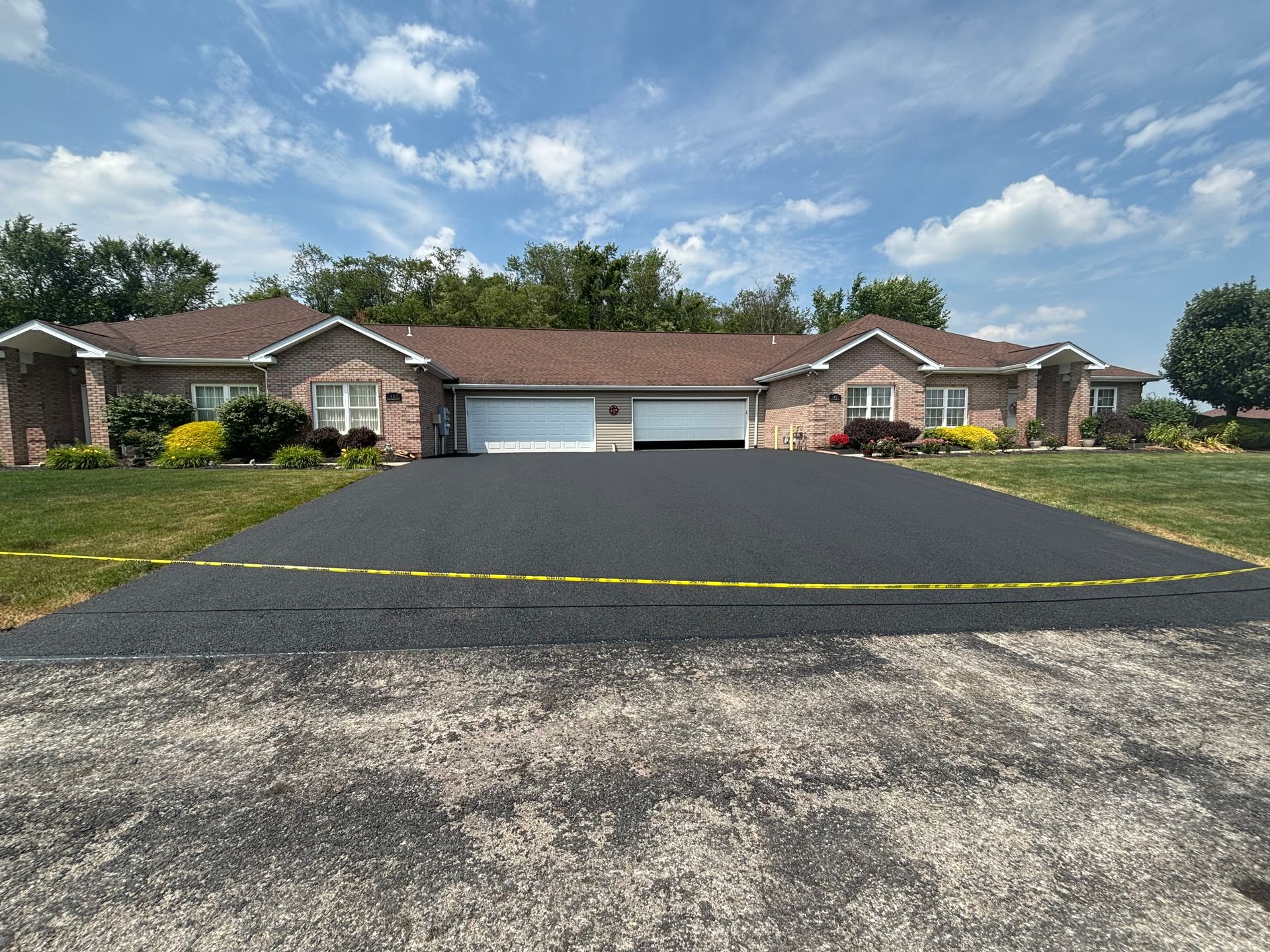 A large house with a large driveway in front of it.