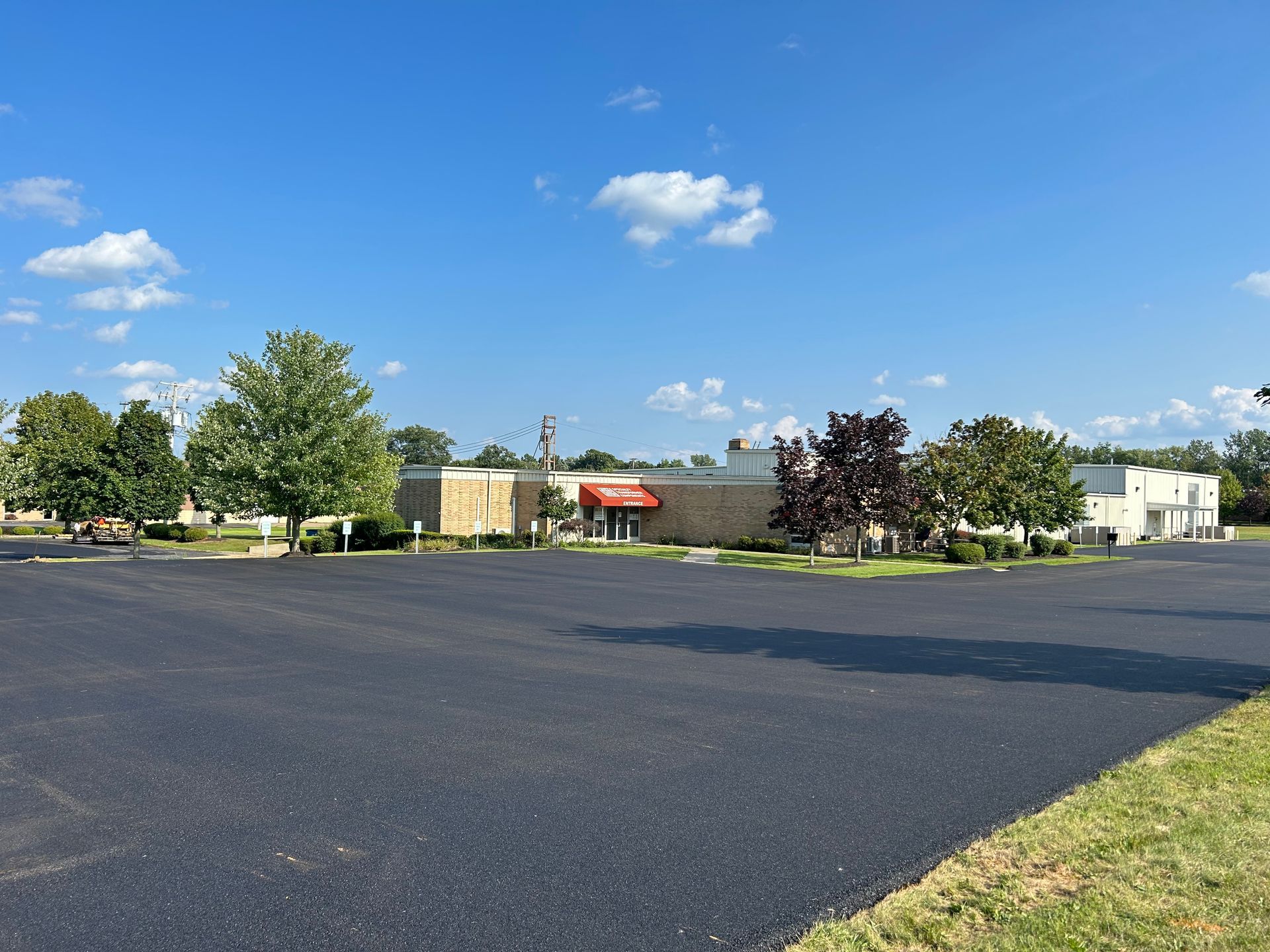A large parking lot with a building in the background