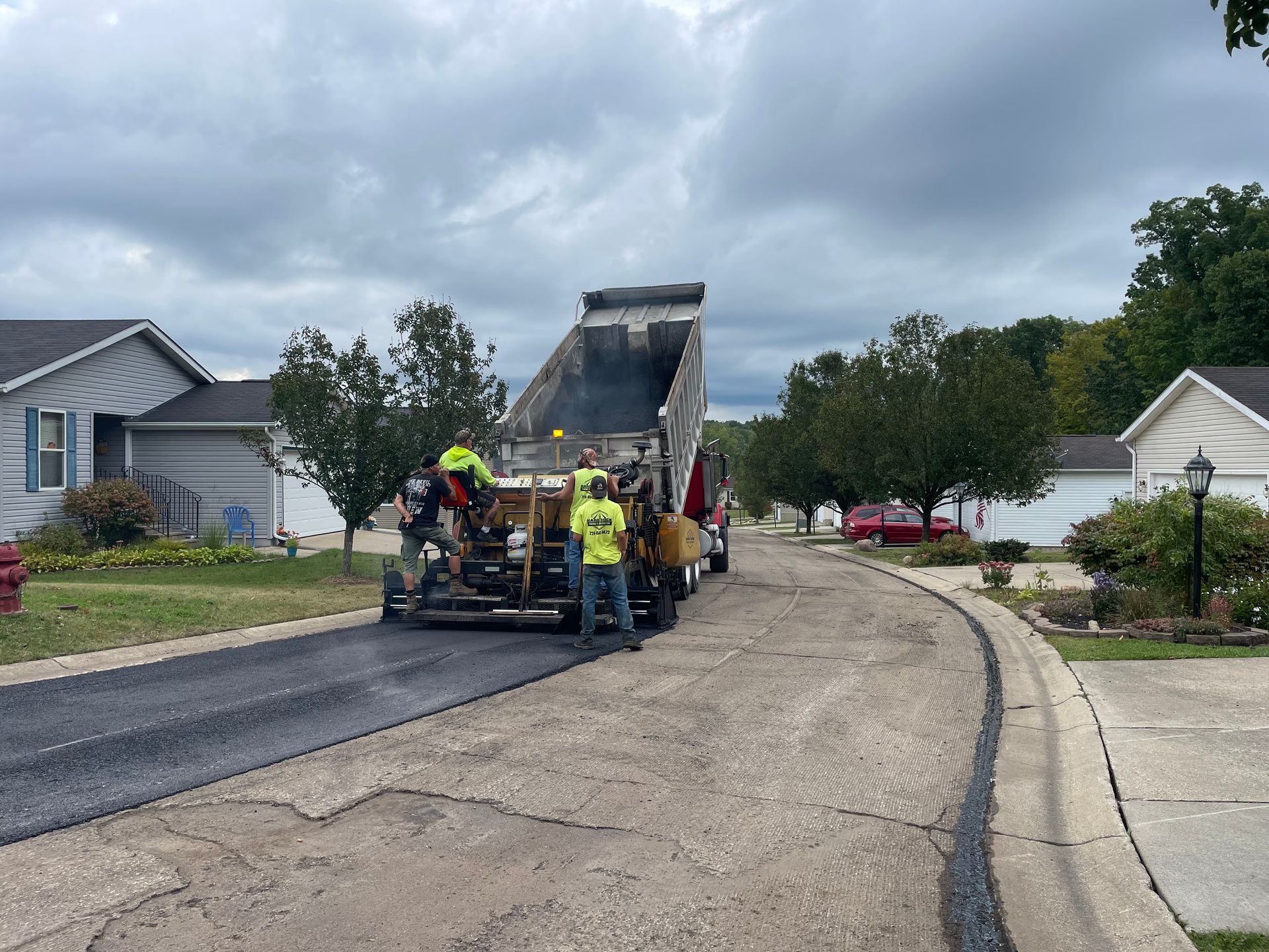 A group of people are working on a road.