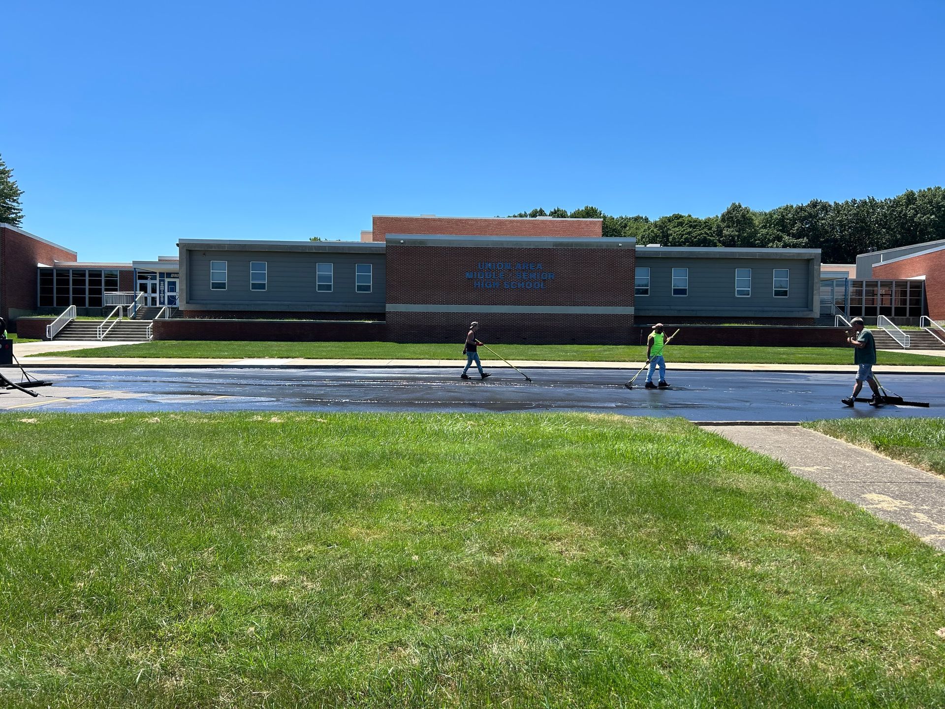 A group of people are standing in front of a large building.