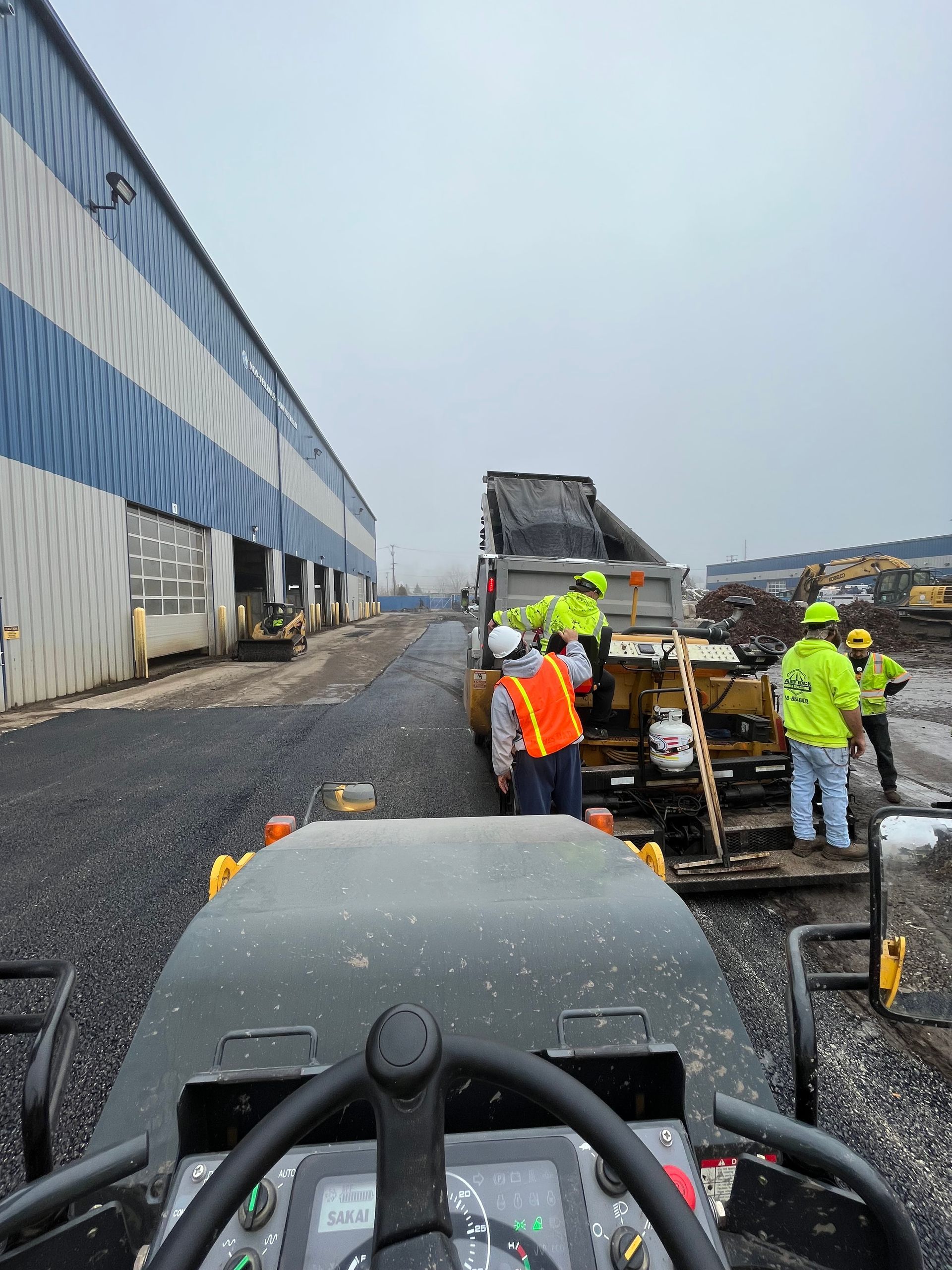 A group of construction workers are working on a road