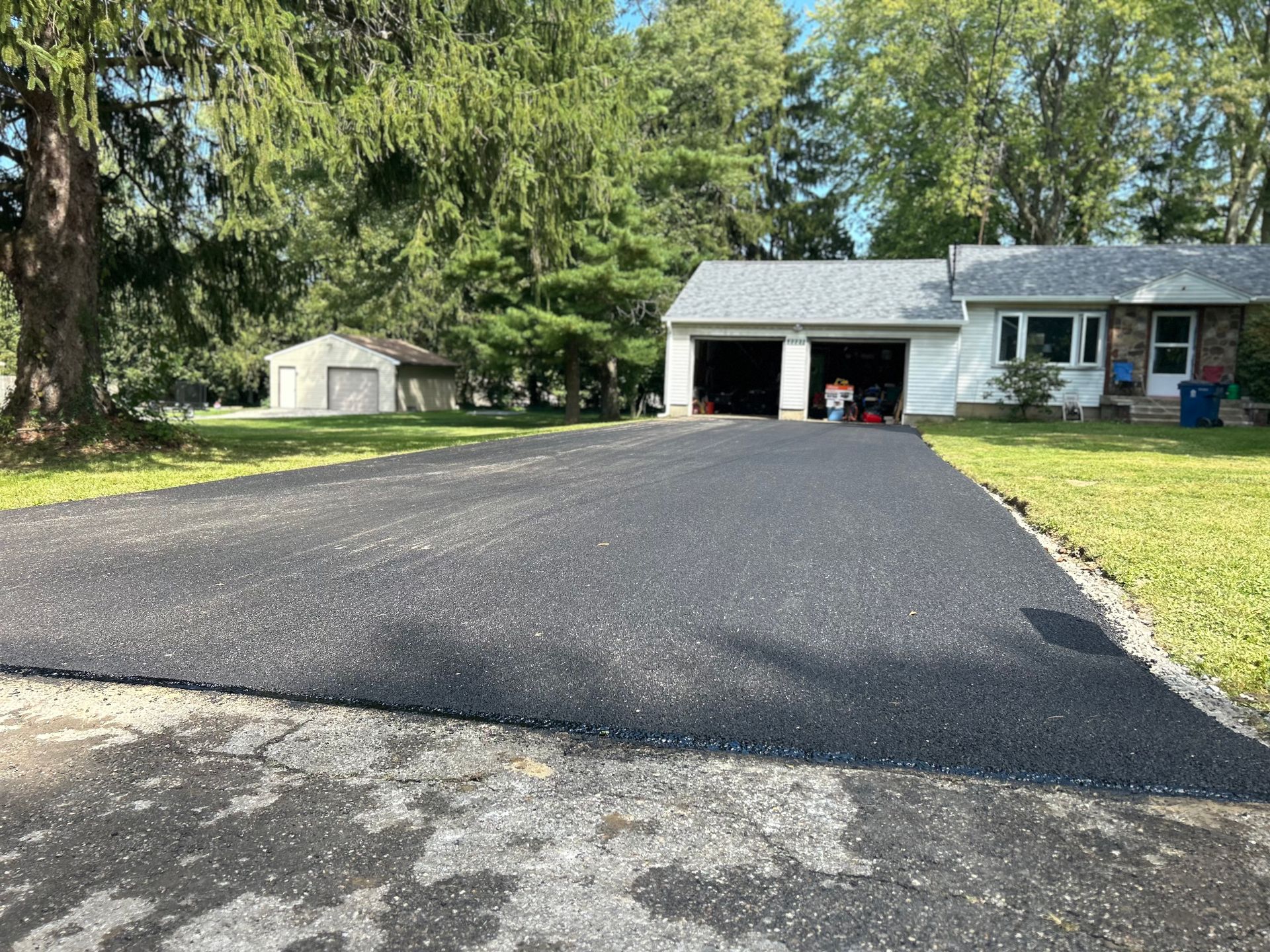 A driveway leading to a house with a garage.
