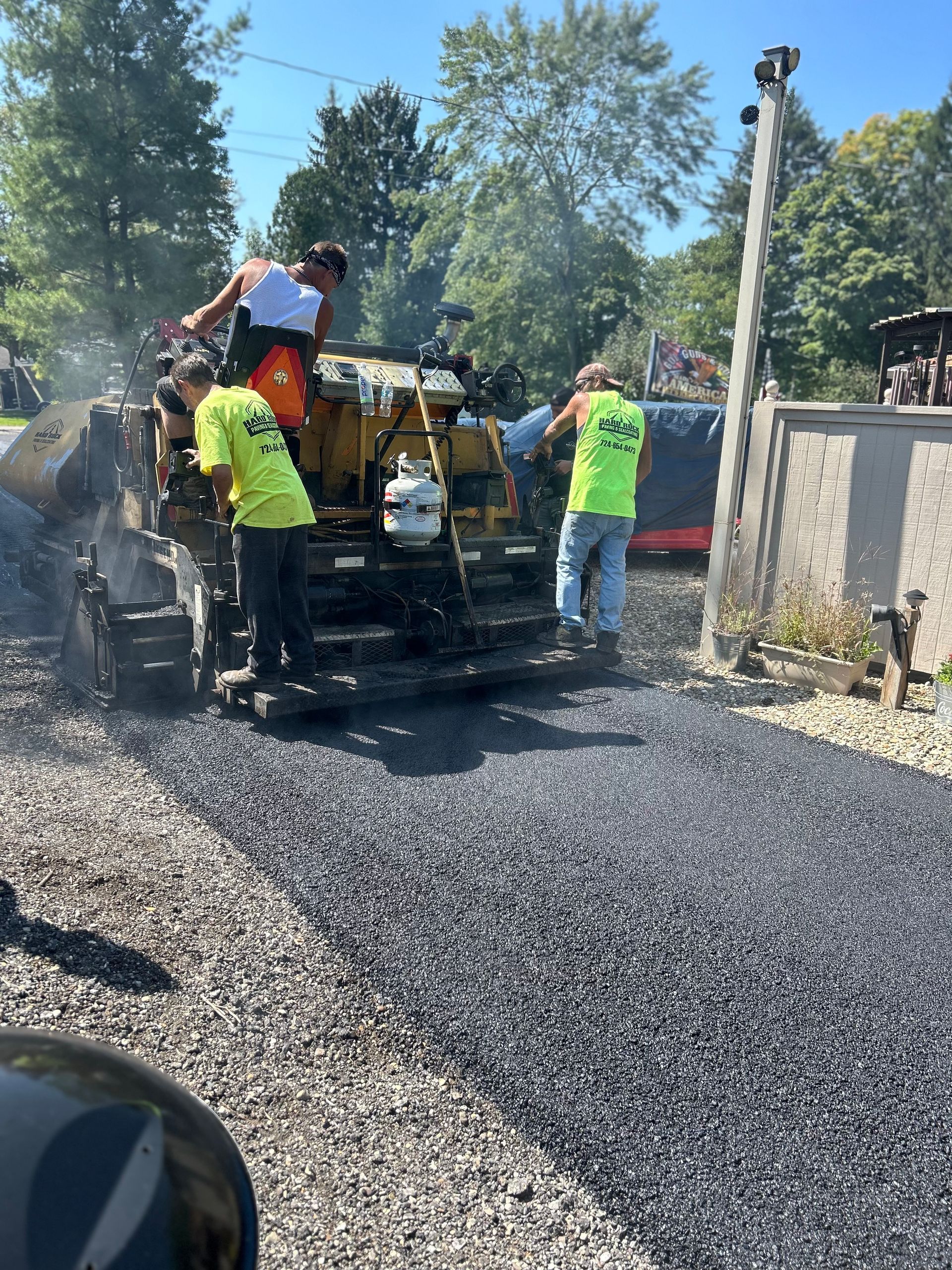 A group of construction workers are working on a road.