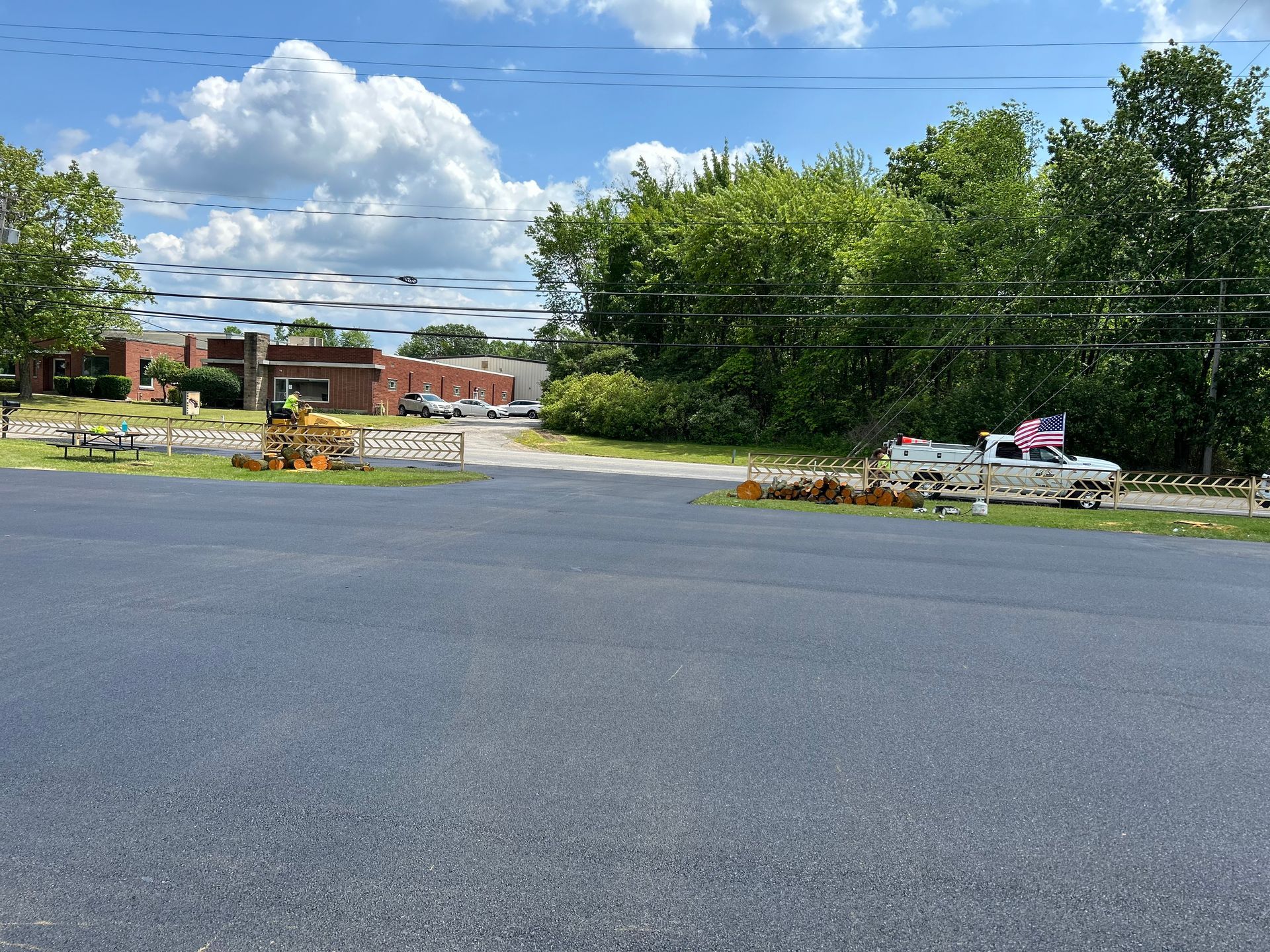 A truck is parked on the side of the road in front of a building.