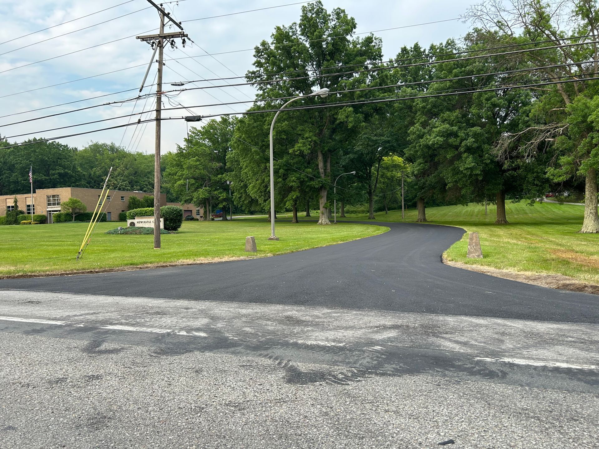 A road that is going through a grassy field