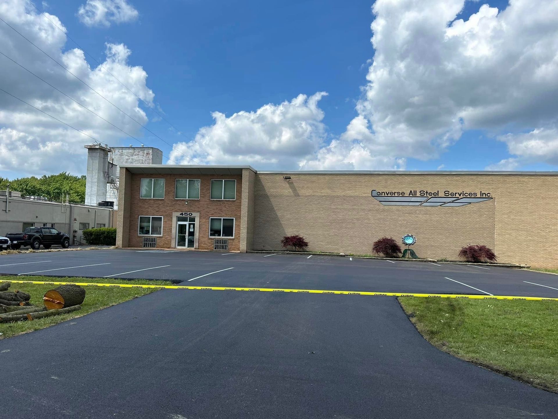 A large brick building with a parking lot in front of it.