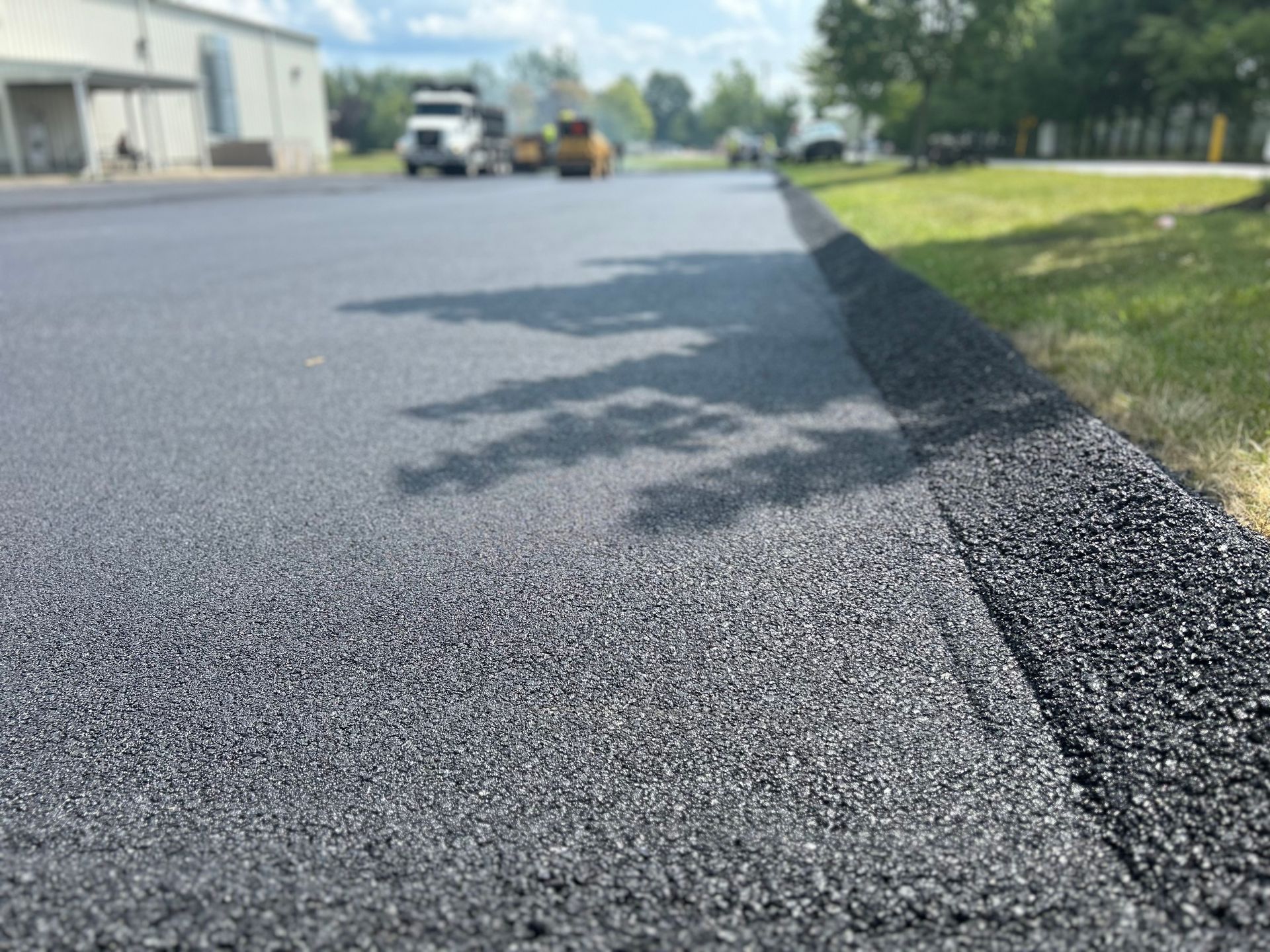 A close up of a road that is being paved.