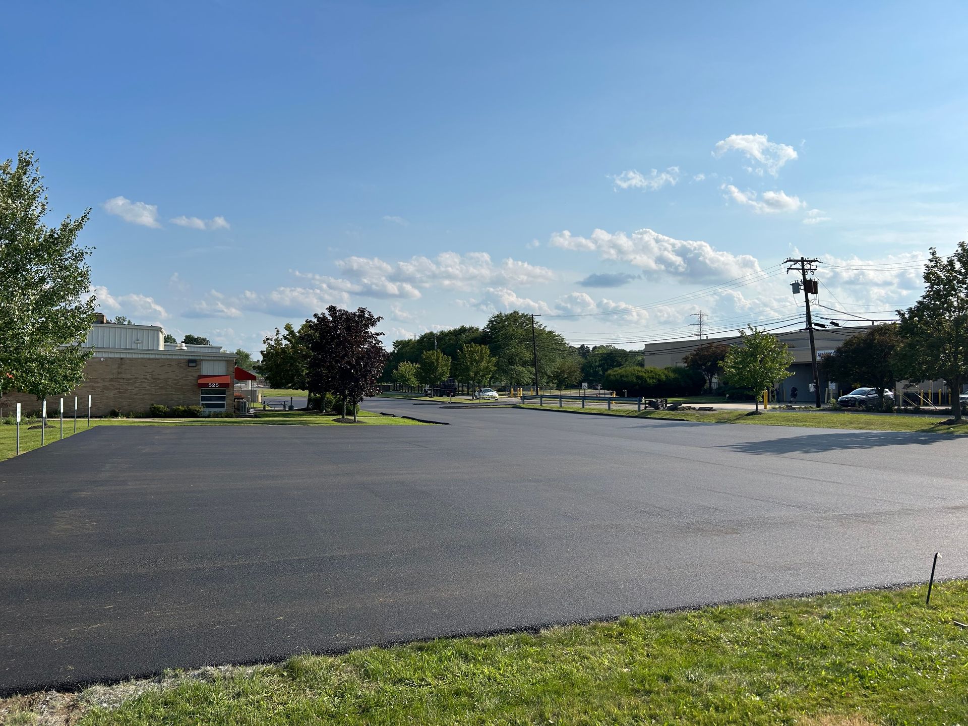 A large empty parking lot with a building in the background.