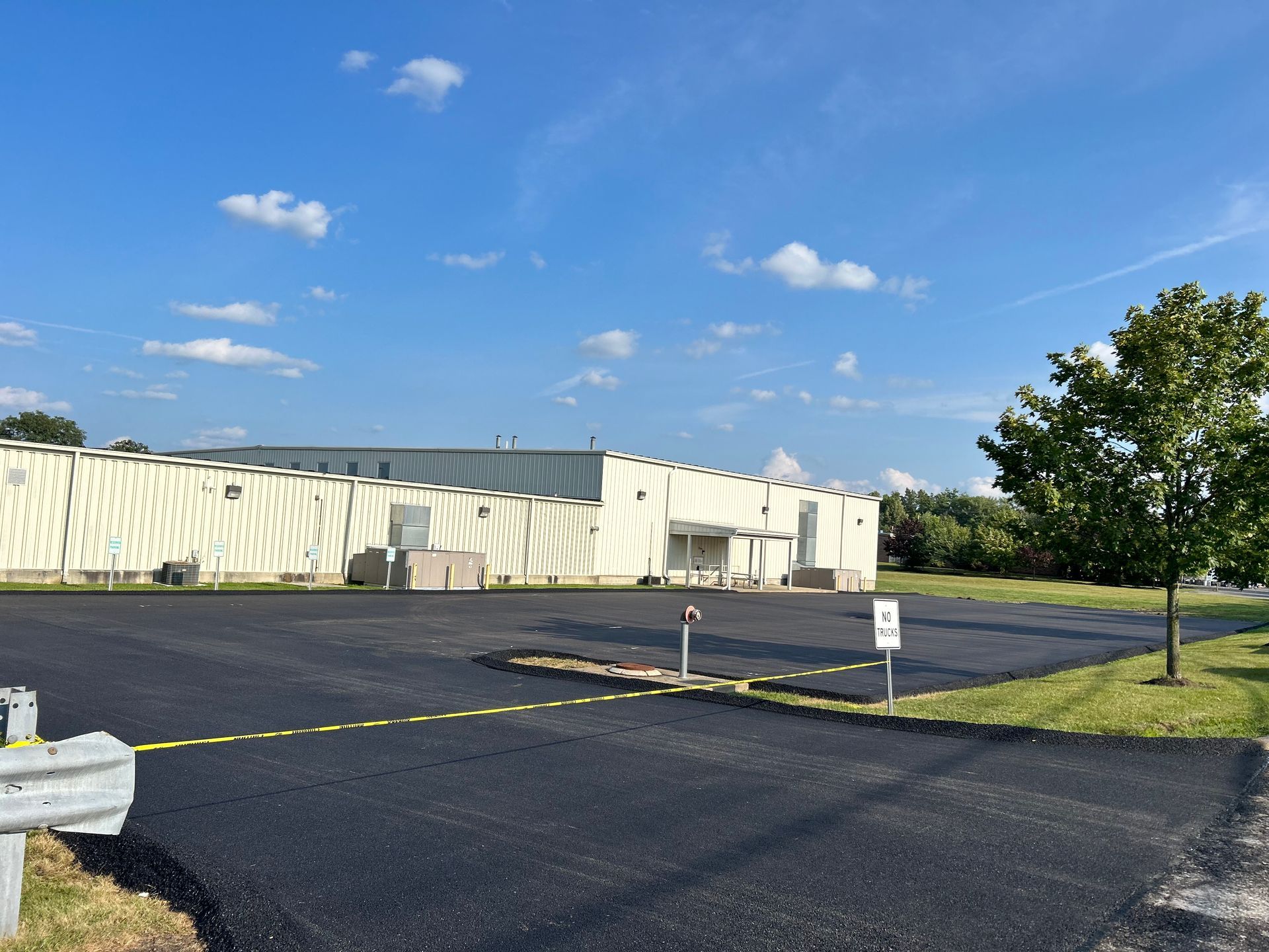 A large white building with a parking lot in front of it.
