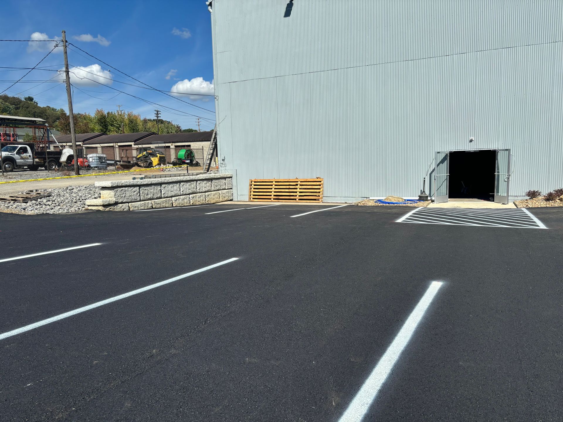 A parking lot in front of a large white building
