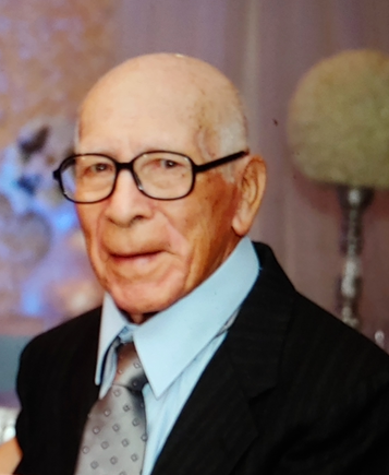 Portrait of a man in glasses and a suit against a softly blurred background