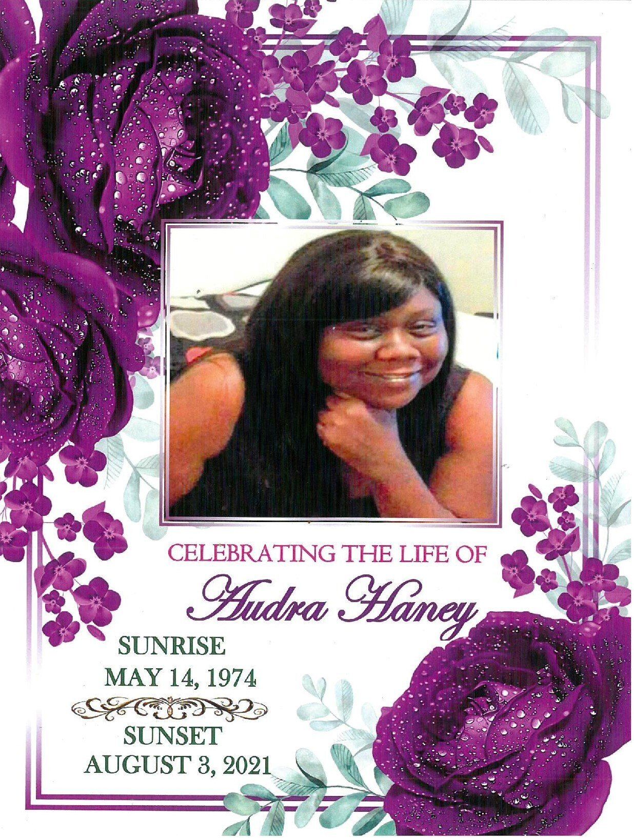 Memorial card with a woman’s portrait, purple flowers, and text honoring “Audra Haney” with dates
