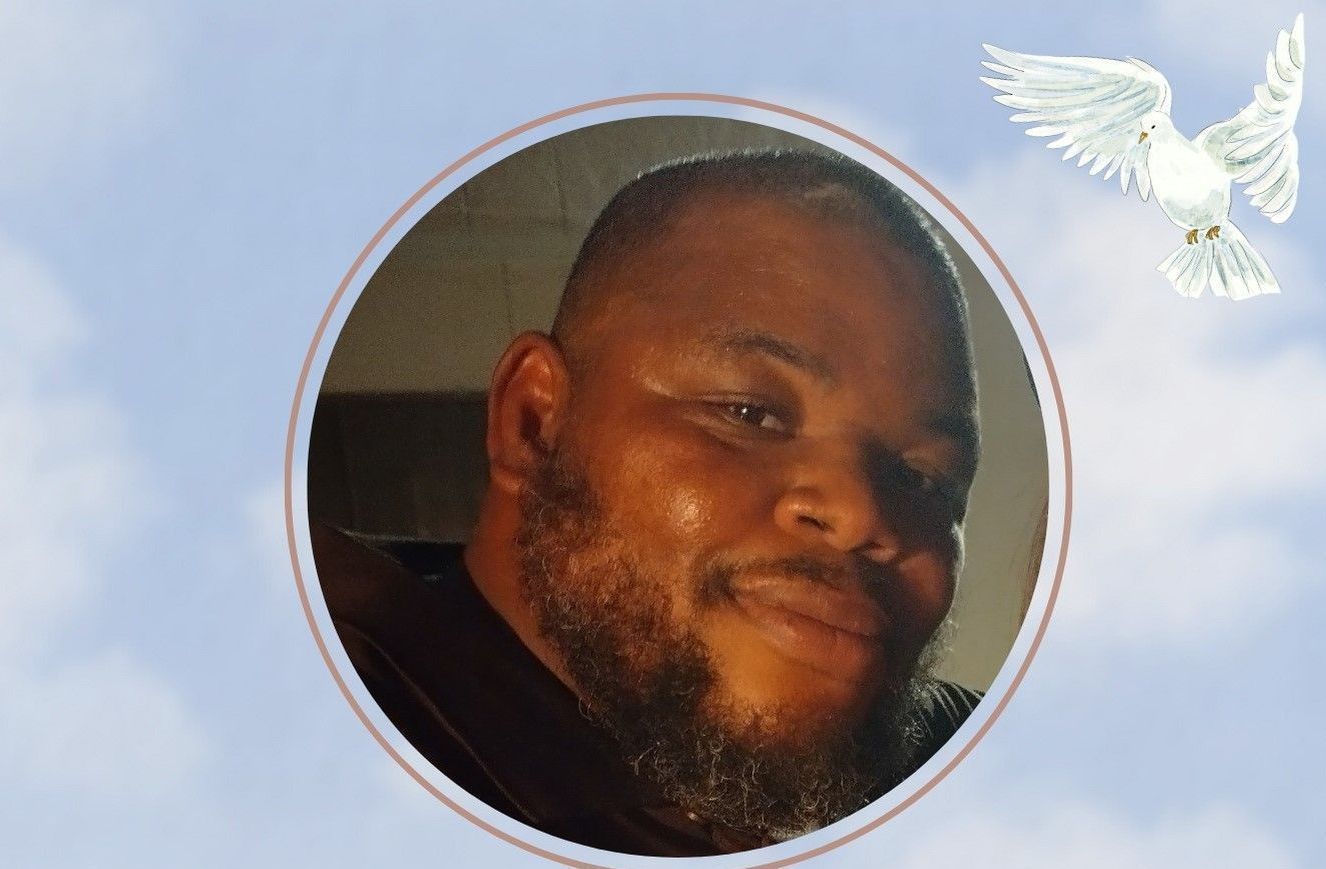Circular profile photo of a smiling man against a blue sky with a white dove graphic
