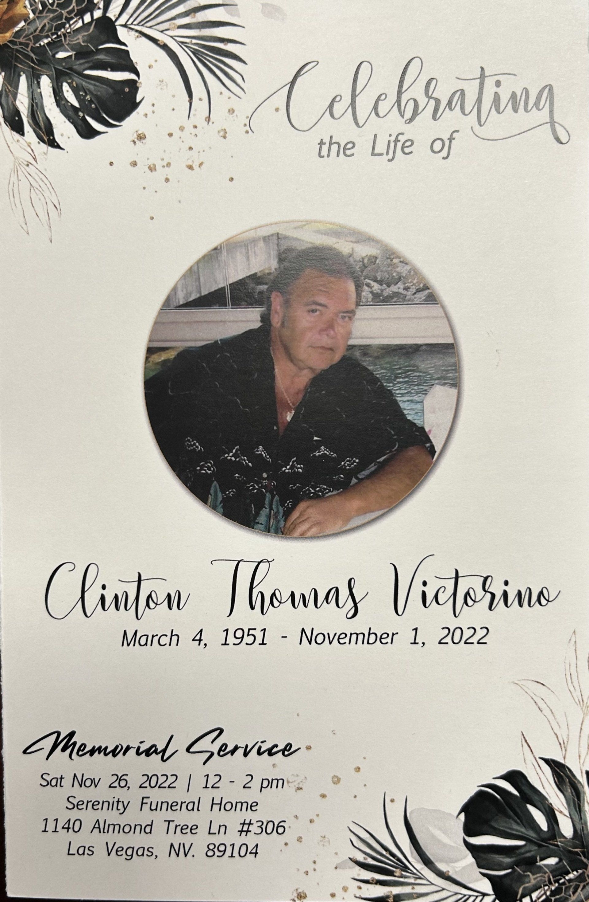 Memorial card with portrait, floral accents, and text reading “Celebrating the Life of Clinton Thomas Victorino.”