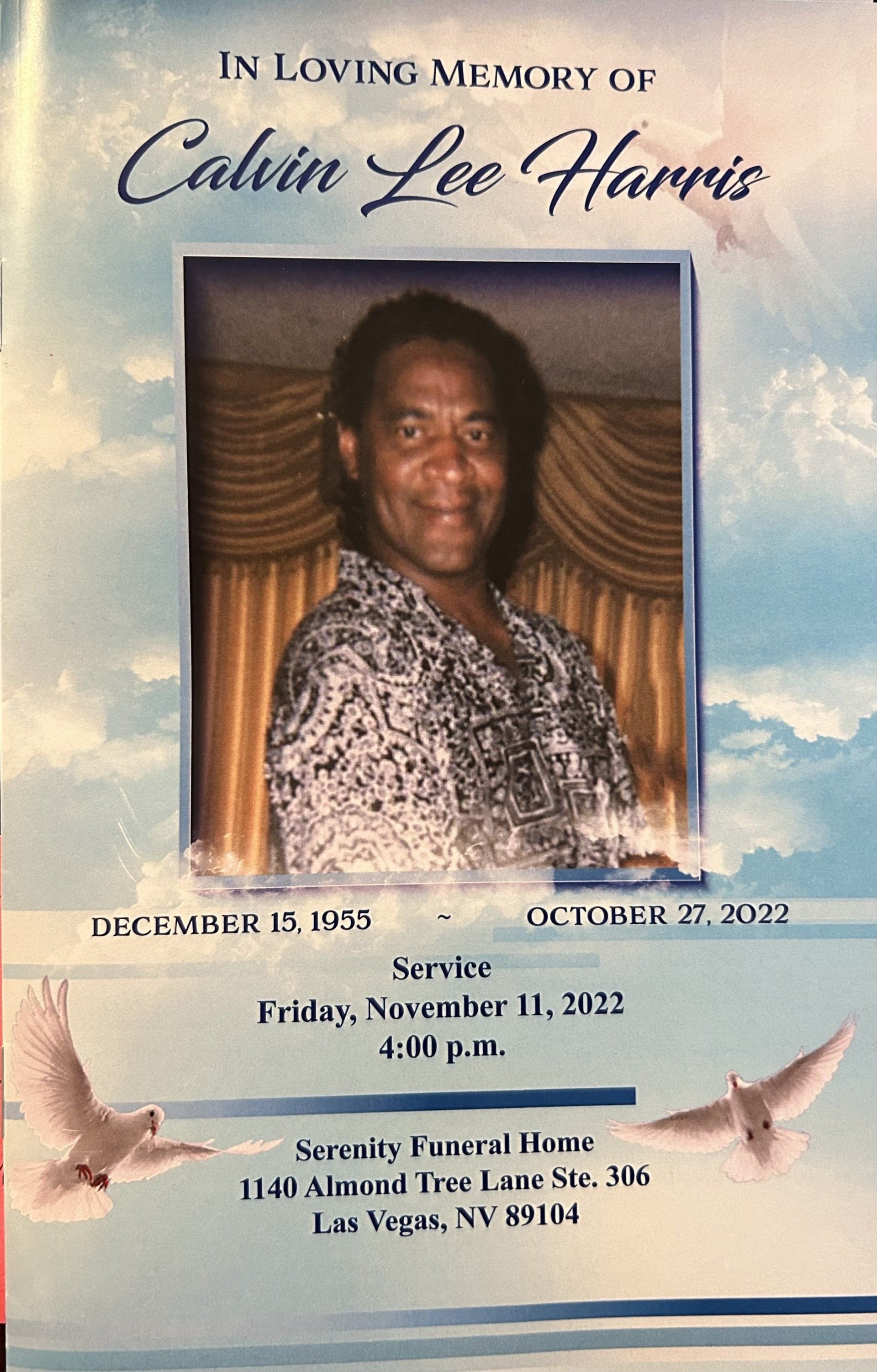 Memorial program for Calvin Lee Harris with portrait, clouds, doves, and funeral service details