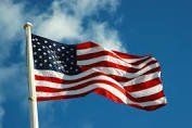 American flag waving against a blue sky
