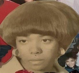 Sepia-toned portrait with a bowl haircut over a red-and-blue background