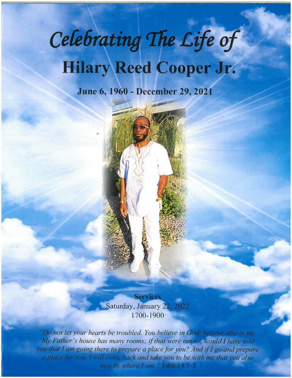 Memorial program cover with a portrait centered on a blue sky and clouds background; text reads 