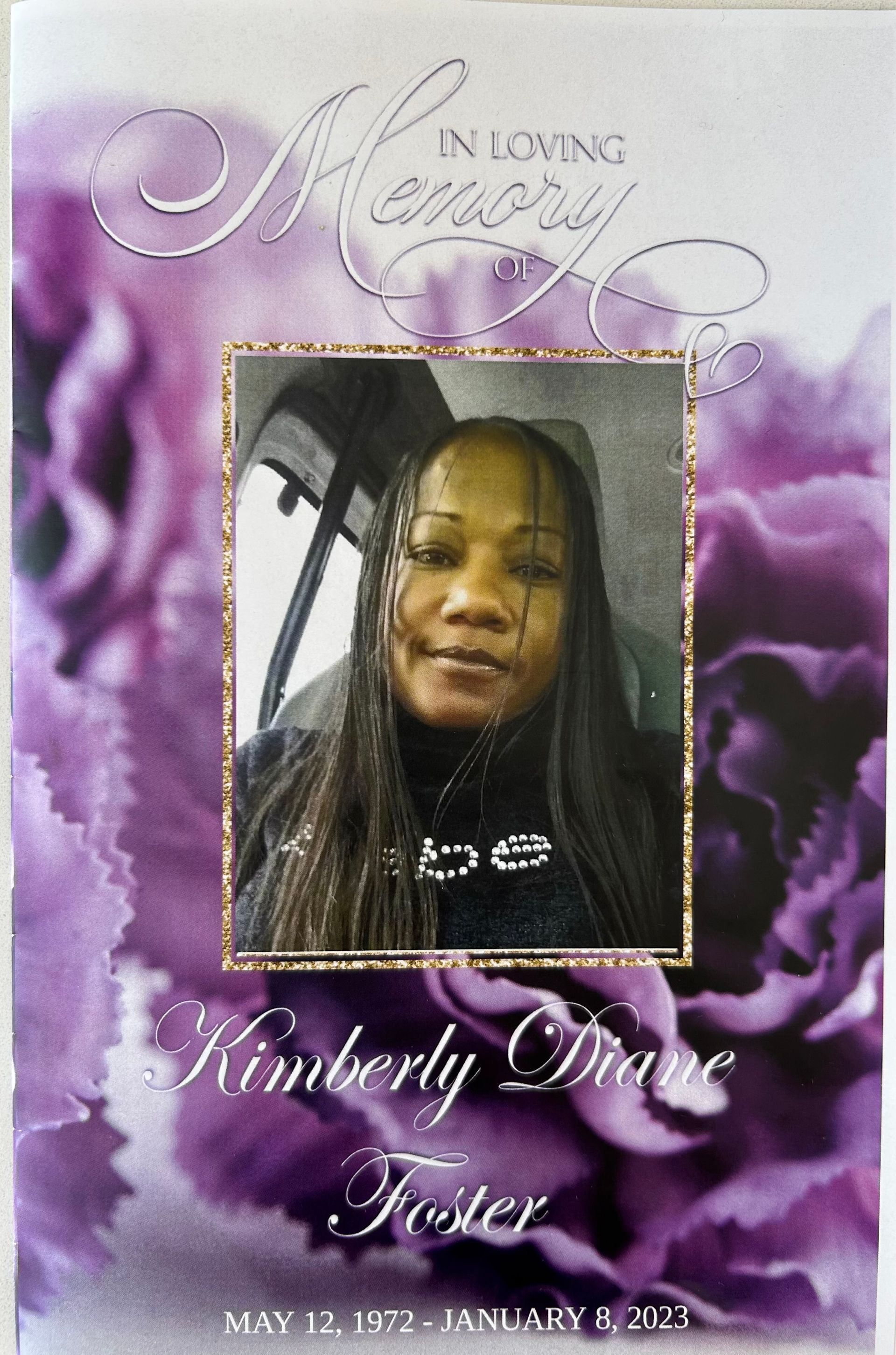 Memorial tribute with a woman’s portrait on a purple cloud background and “In Loving Memory” text.